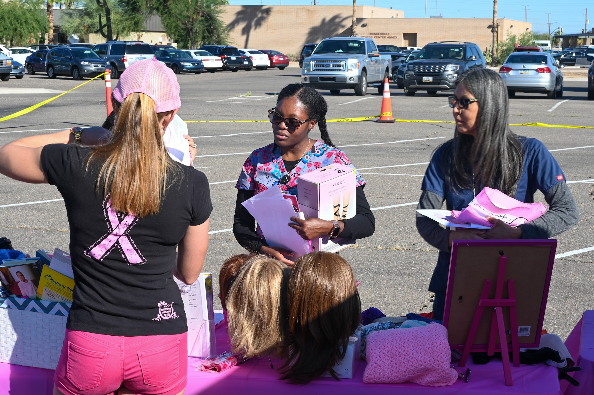 A member of Reba’s Vision showcases some of the accessories given to breast cancer patients during an awareness event Oct. 5, 2022, at Luke Air Force Base, Arizona.