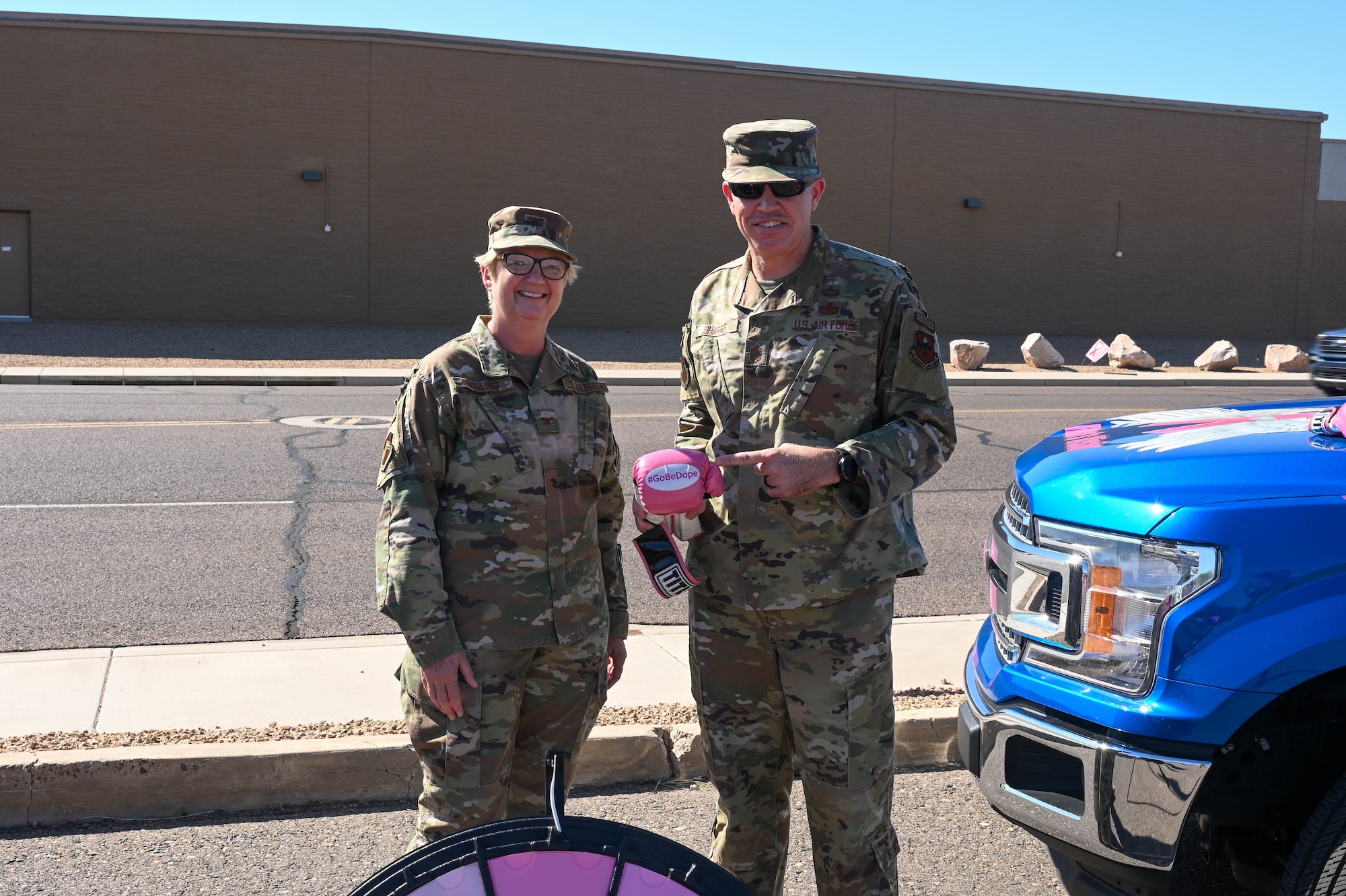U.S. Air Force Col. Colleen Frohling, 56th Medical Group chief nurse executive, and Chief Master Sgt. Jason Shaffer, 56th Fighter Wing command chief, celebrate breast cancer awareness month Oct. 5, 2022, at Luke Air Force Base, Arizona.