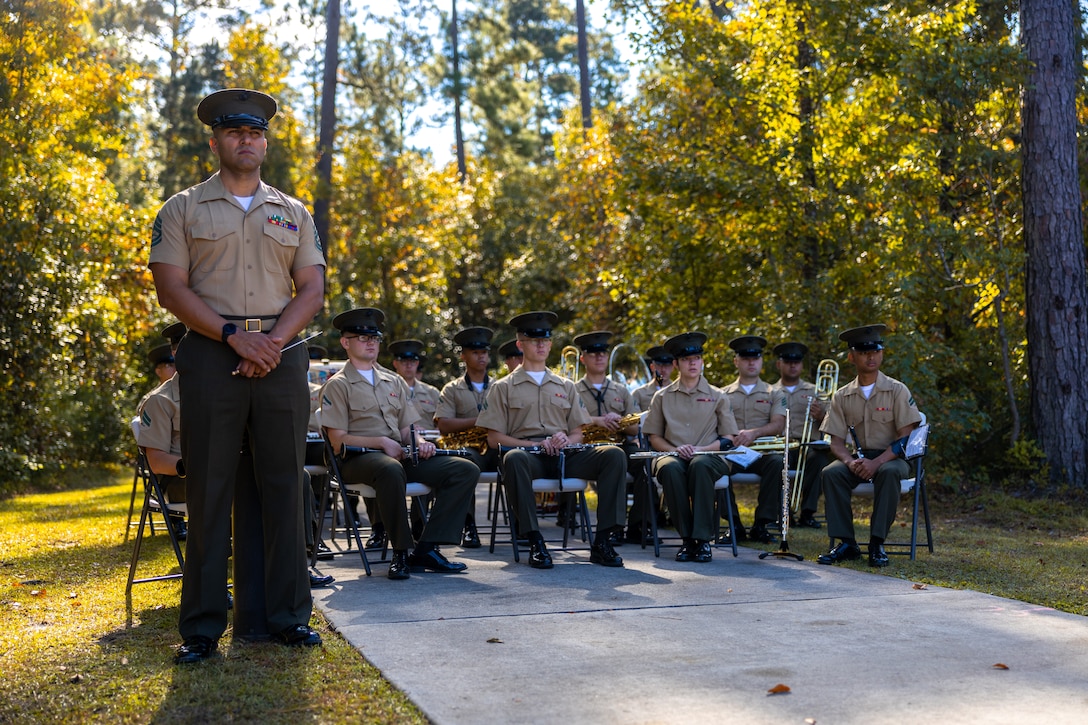 The 2d Marine Division band attends the Corpsman Memorial Dedication Ceremony at Lejeune Memorial Gardens in Jacksonville, North Carolina, Oct. 12, 2022. The Corpsmen Memorial is dedicated to honor all those who served alongside the Marines as Fleet Marine Force Corpsmen in recognition of the duties performed and bonds forged in conflict. (U.S. Marine Corps photo by Cpl. Antonino Mazzamuto)