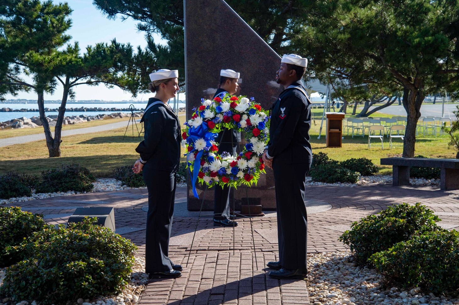 221012-N-CY569-0003 NORFOLK, Va. (Oct. 12, 2022) Sailors assigned to the Arleigh Burke-class, guided-missile destroyer USS Cole (DDG 67) place a wreath at the USS Cole Memorial. Past and present Cole crew members gathered alongside families and guests at the memorial onboard Naval Station Norfolk to commemorate the 22nd anniversary of the ship's bombing on October 12, 2000. (U.S. Navy photo by Mass Communication Specialist 3rd Class Anthony Robledo)