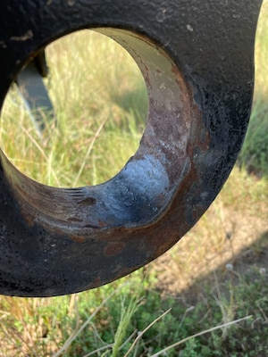 A medal lifting eye showing an excessive wear mark from use.