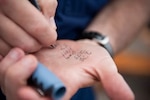 U.S. Coast Guard Capt. Eric Jones writes on his hand Monday, July 25, 2011, aboard the Coast Guard Cutter Eagle in Boston. Jones is the commanding officer of the Eagle and wrote lifesaving information down on his hand during an abandon ship exercise. U.S. Coast Guard photo by Petty Officer 1st Class NyxoLyno Cangemi