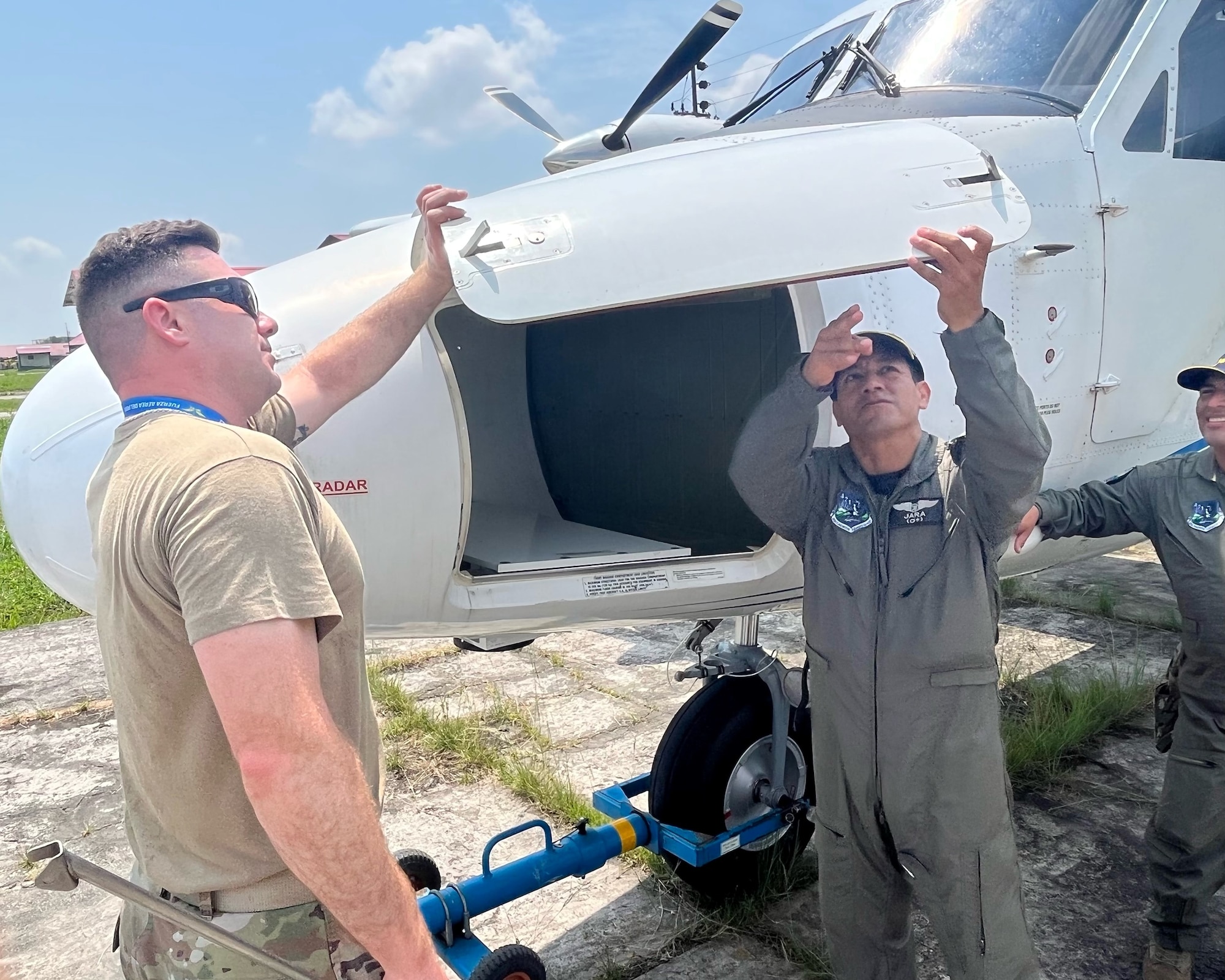 Tech. Sgt. Jacob Haines, left, a 571st Mobility Support Advisory Squadron advisor, inspects a DHC-6 Twin Otter aircraft with Fuerza Aérea de Peru’s Lt. Carlos Benzaquen-Cancela, right, a Grupo Aereo N. 42 DHC-6 instructor pilot, Sept. 1, 2022, in Base Area Coronel Francisco Secada Vignetta Air Base, Peru. The DHC-6 Twin Otter aircraft was a focal point during the out-in-the-field training between the two air force military service organizations. (U.S. Air Force photo by Tech. Sgt. Anthony Garcia)