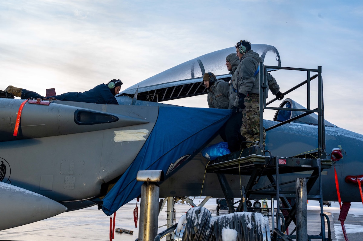 U.S. Air Force 44th Aircraft Maintenance Unit crew chiefs perform routine maintenance checks on an F-15C/D Eagle at Eielson Air Force Base, Alaska, Oct. 12, 2022.