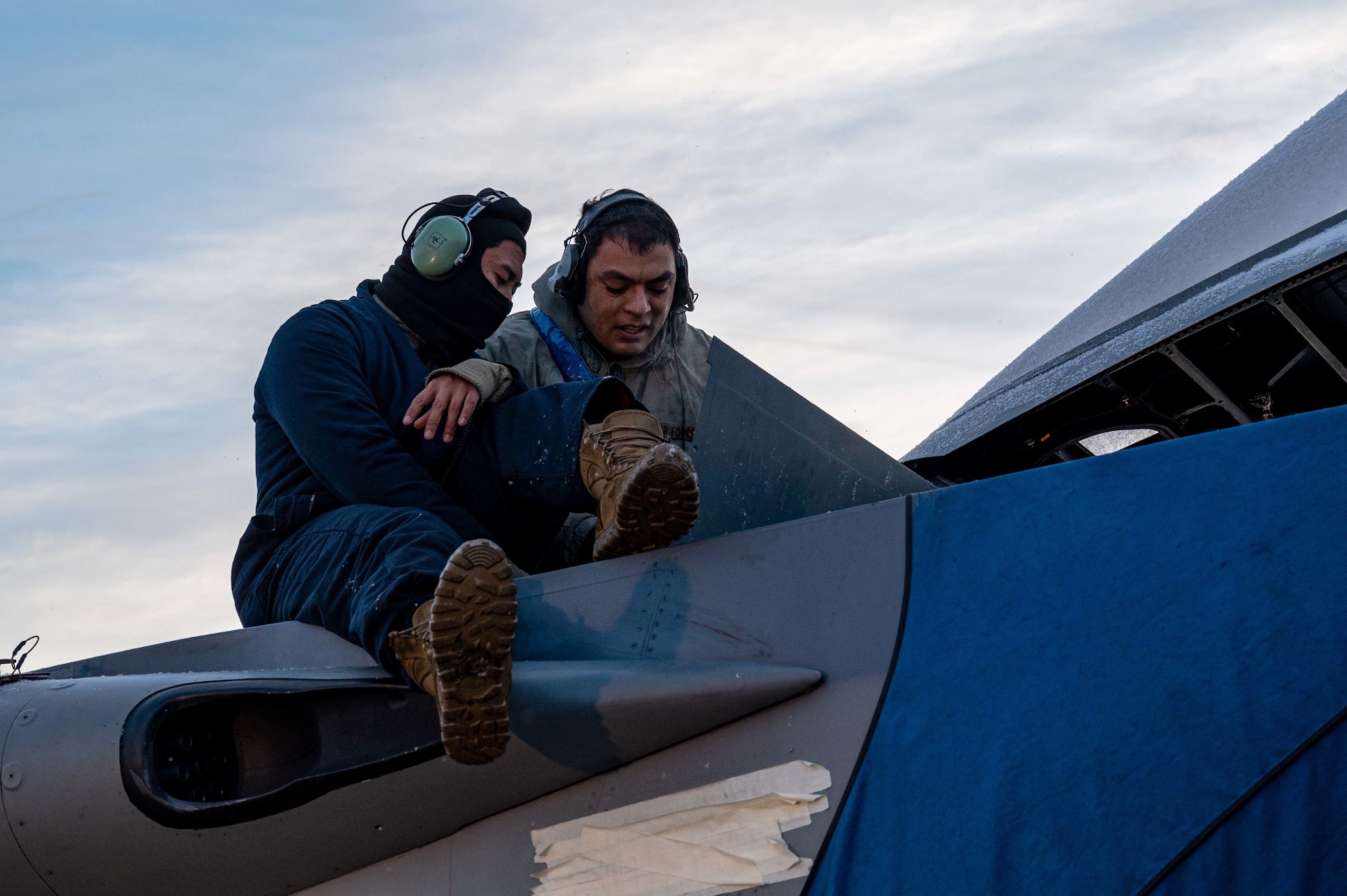 U.S. Air Force Staff Sergeant Patrick Handy and Senior Airman Clark-Kent Pacay, 44th Aircraft Maintenance Unit crew chiefs, perform routine maintenance checks on an F-15C/D Eagle during RED FLAG-Alaska (RF-A) 23-1 at Eielson Air Force Base, Alaska, Oct. 12, 2022.