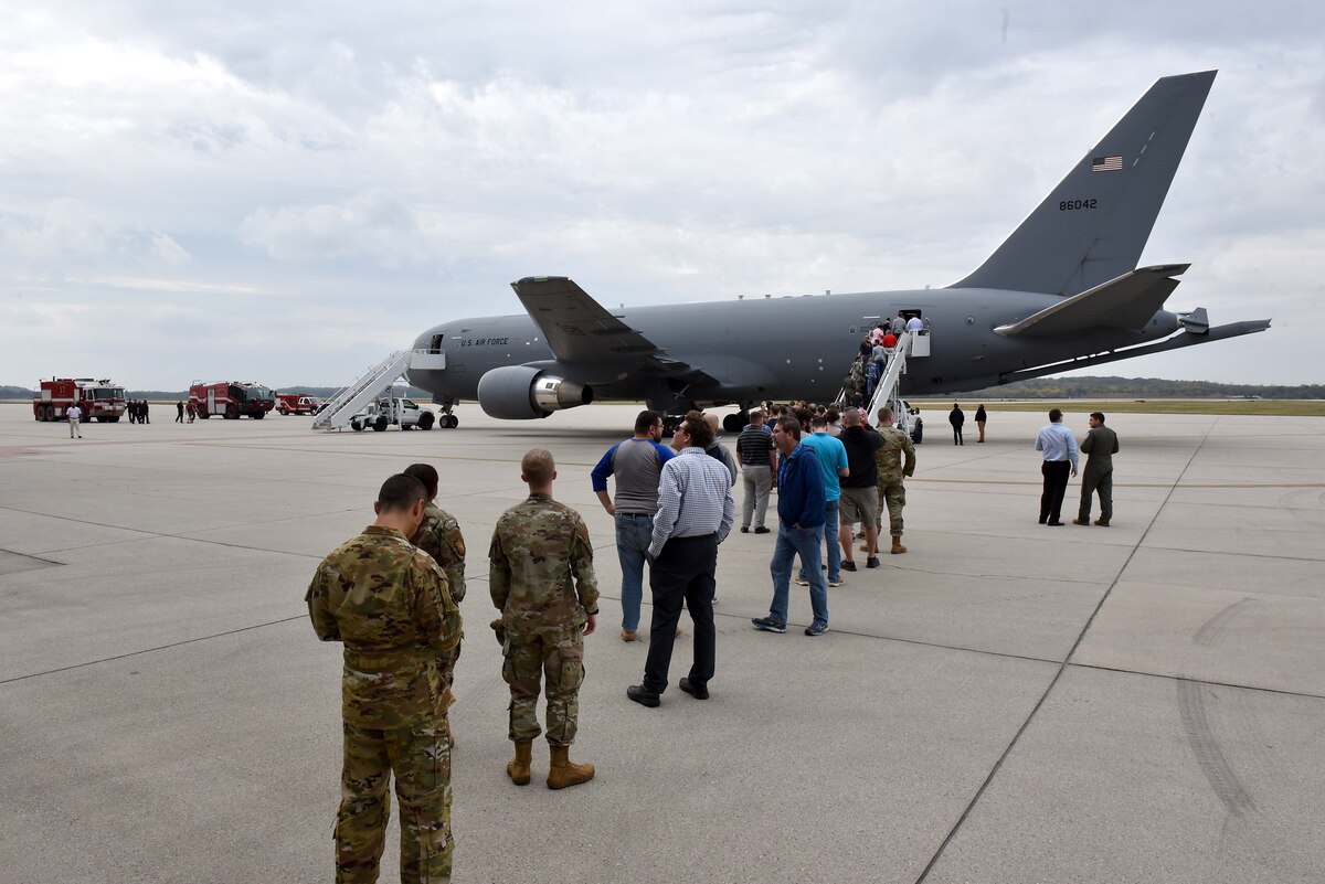 People stand in line to tour an aircraft.