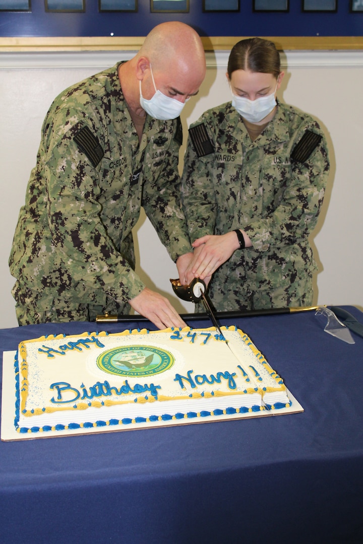Photo of two sailors cutting the U.S. Navy birthday cake.
