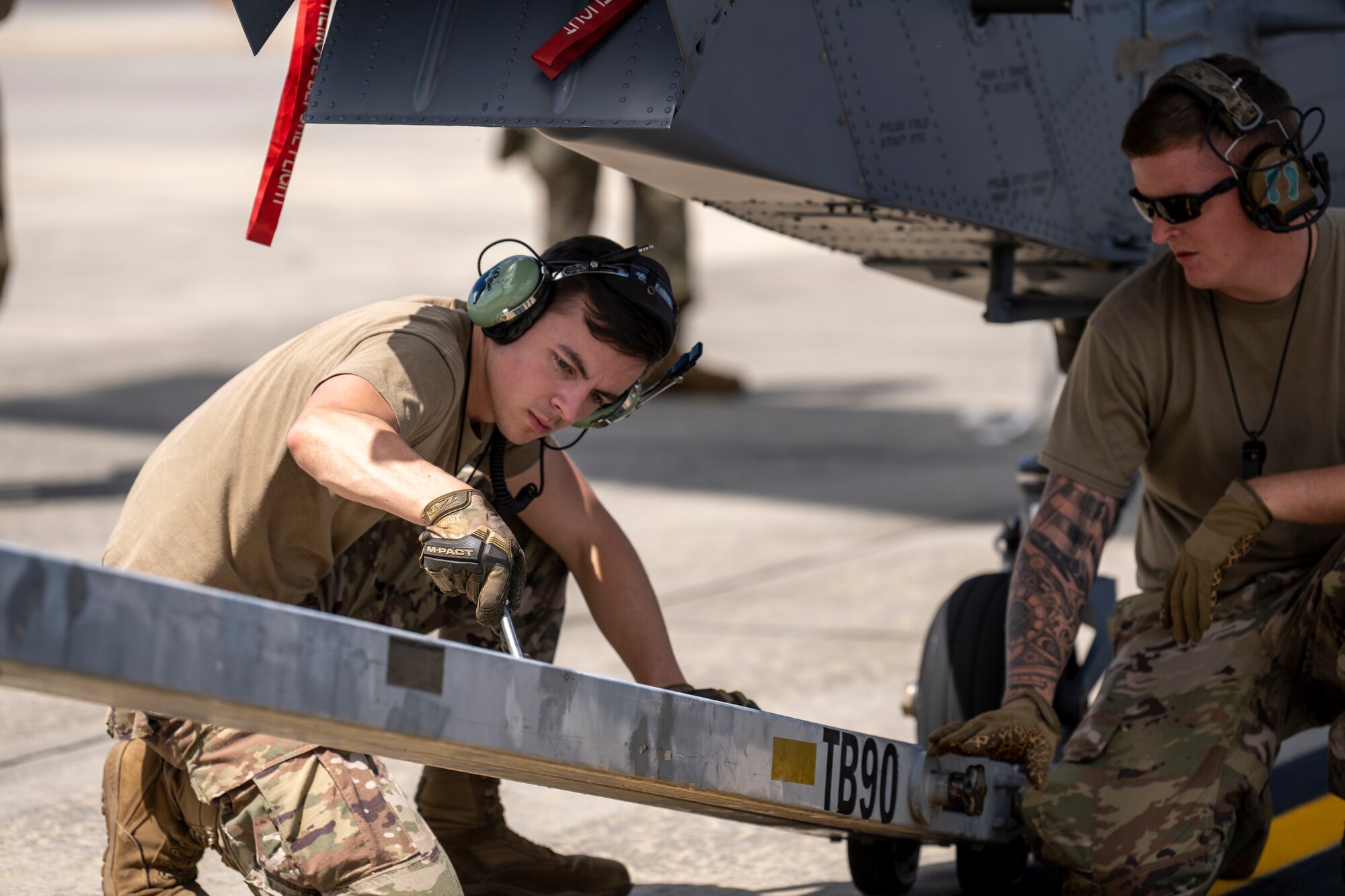 Airmen assigned to the 23rd Wing prepare to load an HH-60W Jolly Green II onto a C-17 Globemaster III