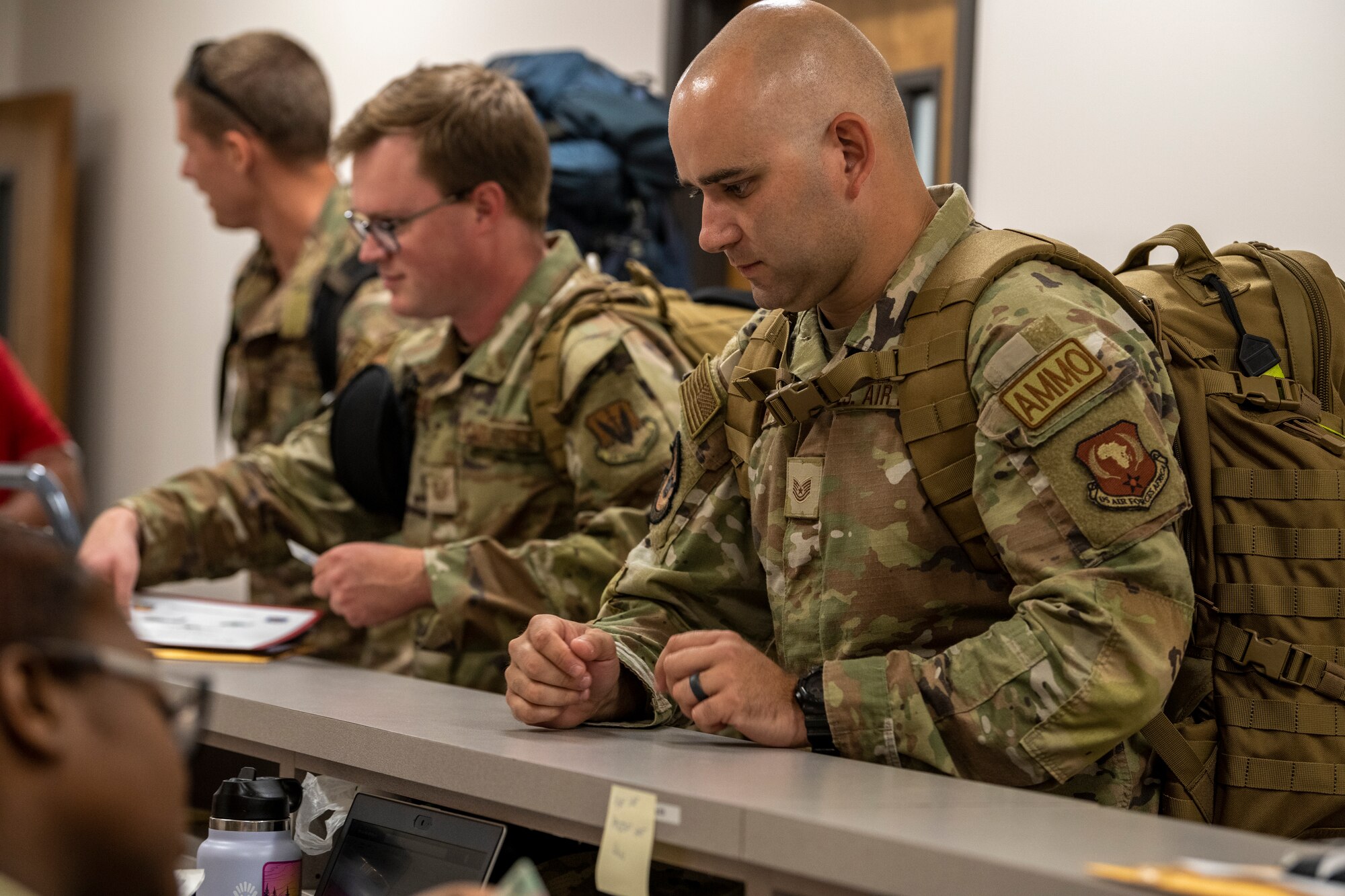 Airmen process through a deployment line.