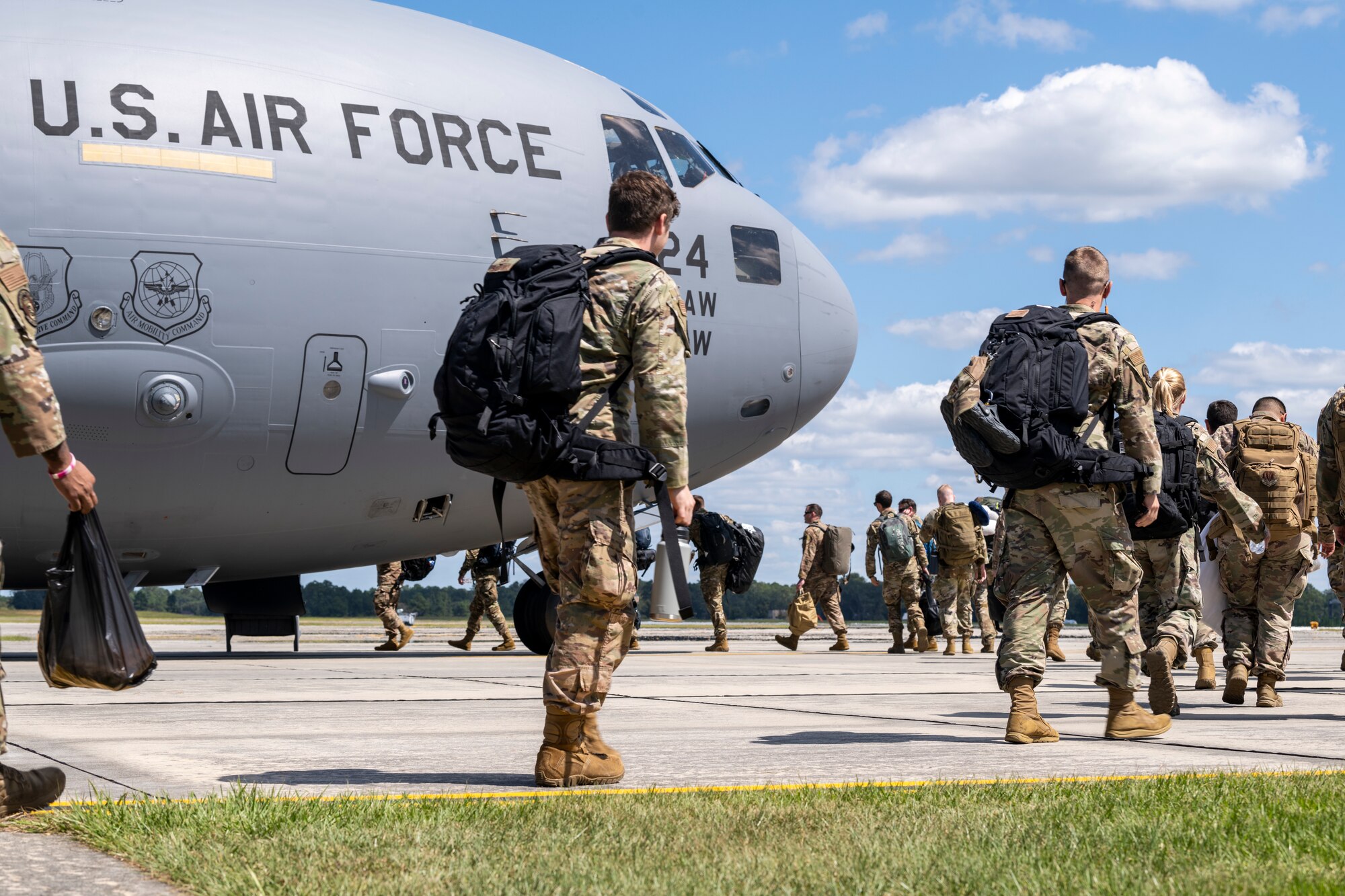 Airmen load onto a plane