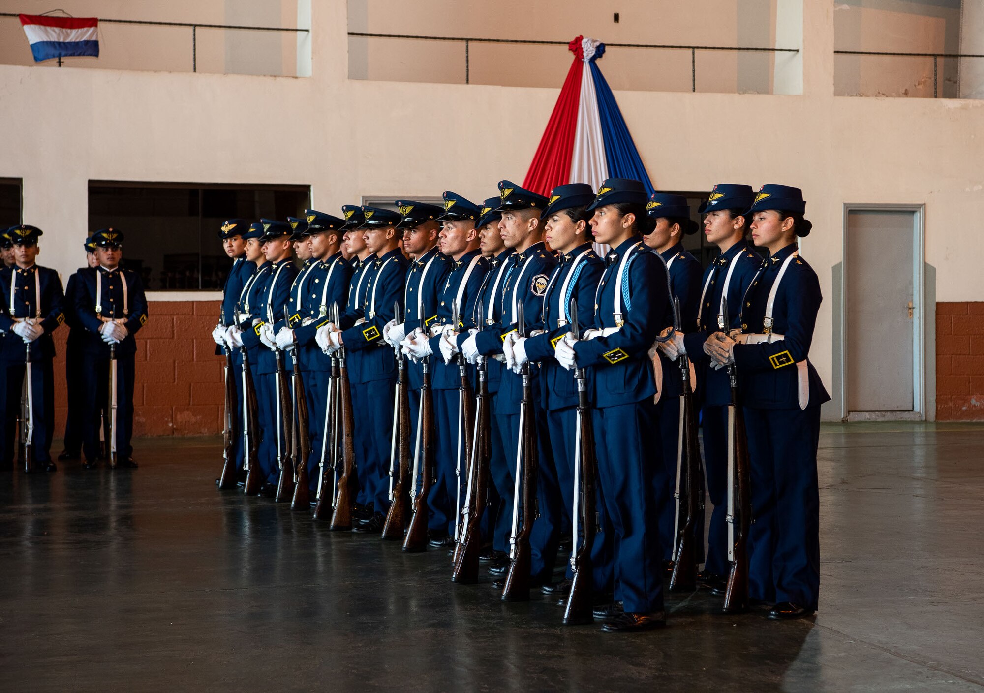 Drill team members are lined up and standing in formation