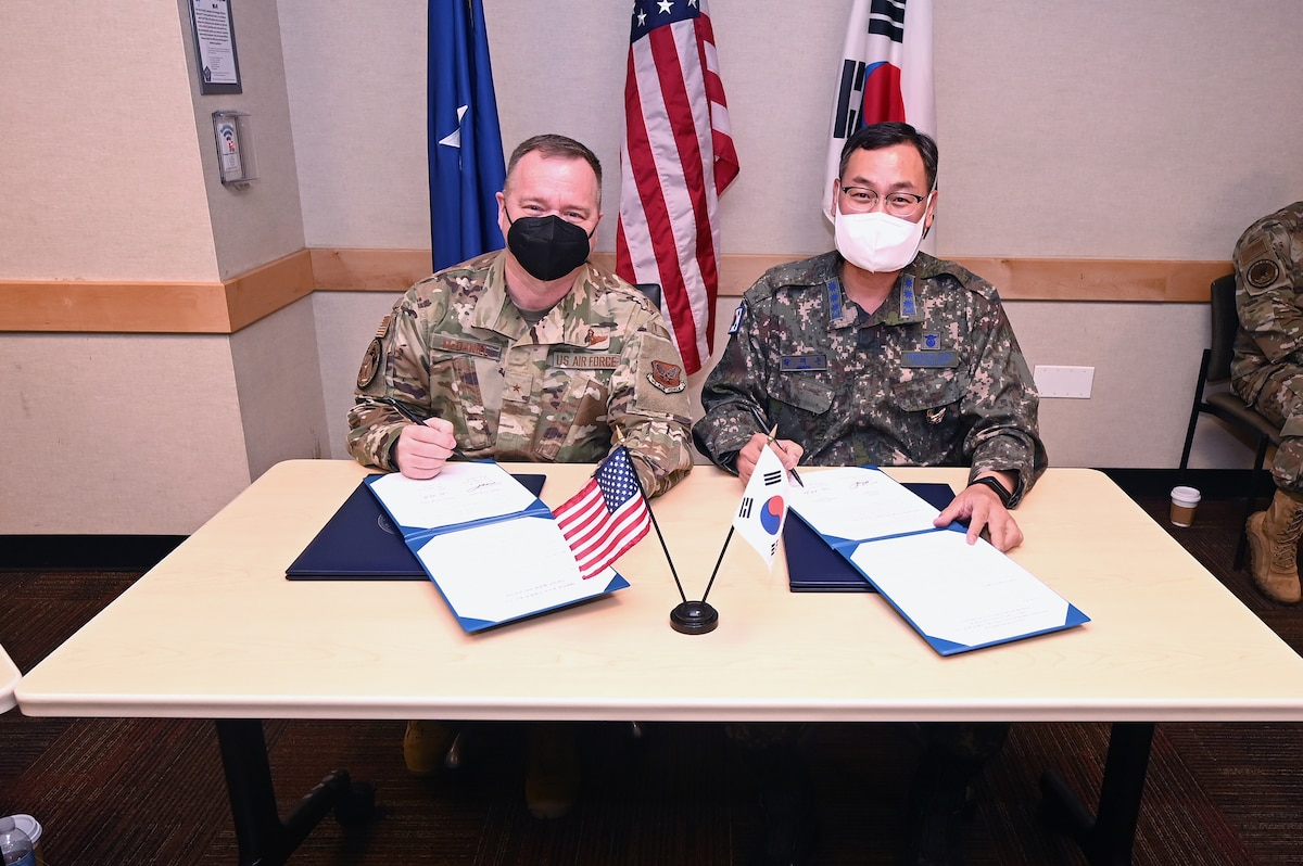 U.S. Air Force Brig. Gen. Charles McDaniel, U.S. Air Force director of Weather, and Republic of Korea Air Force Col. Hwang Jae Don, ROKAF Weather Wing commander, sign terms of reference during a meeting at the Pentagon in Arlington, Va., May 23, 2022. (U.S. Air Force photo by Andy Morataya)
