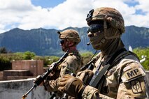 U.S. Army Staff Sgt. Benjamin Colson, a squad leader with 2nd Platoon, 58th Military Police Company, awaits further instruction during a platoon exercise, Marine Corps Training Area Bellows, Hawaii, Sept. 28, 2022. The purpose of the exercise was to increase readiness when operating as a platoon sized element in populated urban terrain. (U.S. Marine Corps photo by Cpl. Samantha Sanchez)