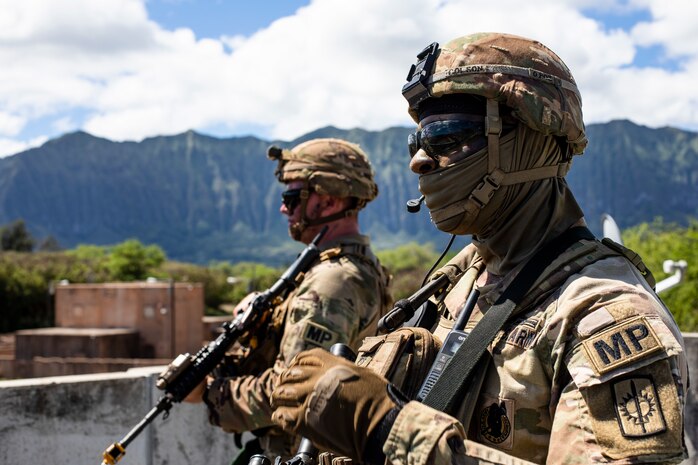 U.S. Army Staff Sgt. Benjamin Colson, a squad leader with 2nd Platoon, 58th Military Police Company, awaits further instruction during a platoon exercise, Marine Corps Training Area Bellows, Hawaii, Sept. 28, 2022. The purpose of the exercise was to increase readiness when operating as a platoon sized element in populated urban terrain. (U.S. Marine Corps photo by Cpl. Samantha Sanchez)