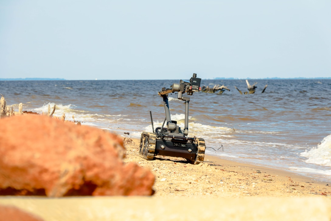 A Man Transportable Robot System, a robot used by explosive ordnance disposal technicians to remotely diffuse ordnance, moves towards a boat during the Sudden Crisis 2022 training exercise at Marine Corps Air Station Cherry Point, North Carolina, Oct. 11, 2022. The training event exercised command and control, reporting, interoperability with external organizations, and validated tactics, techniques and procedures, in the event the air station needs to elevate its force protection condition.  (U.S. Marine Corps photo by Lance Cpl. Tristen Reed)
