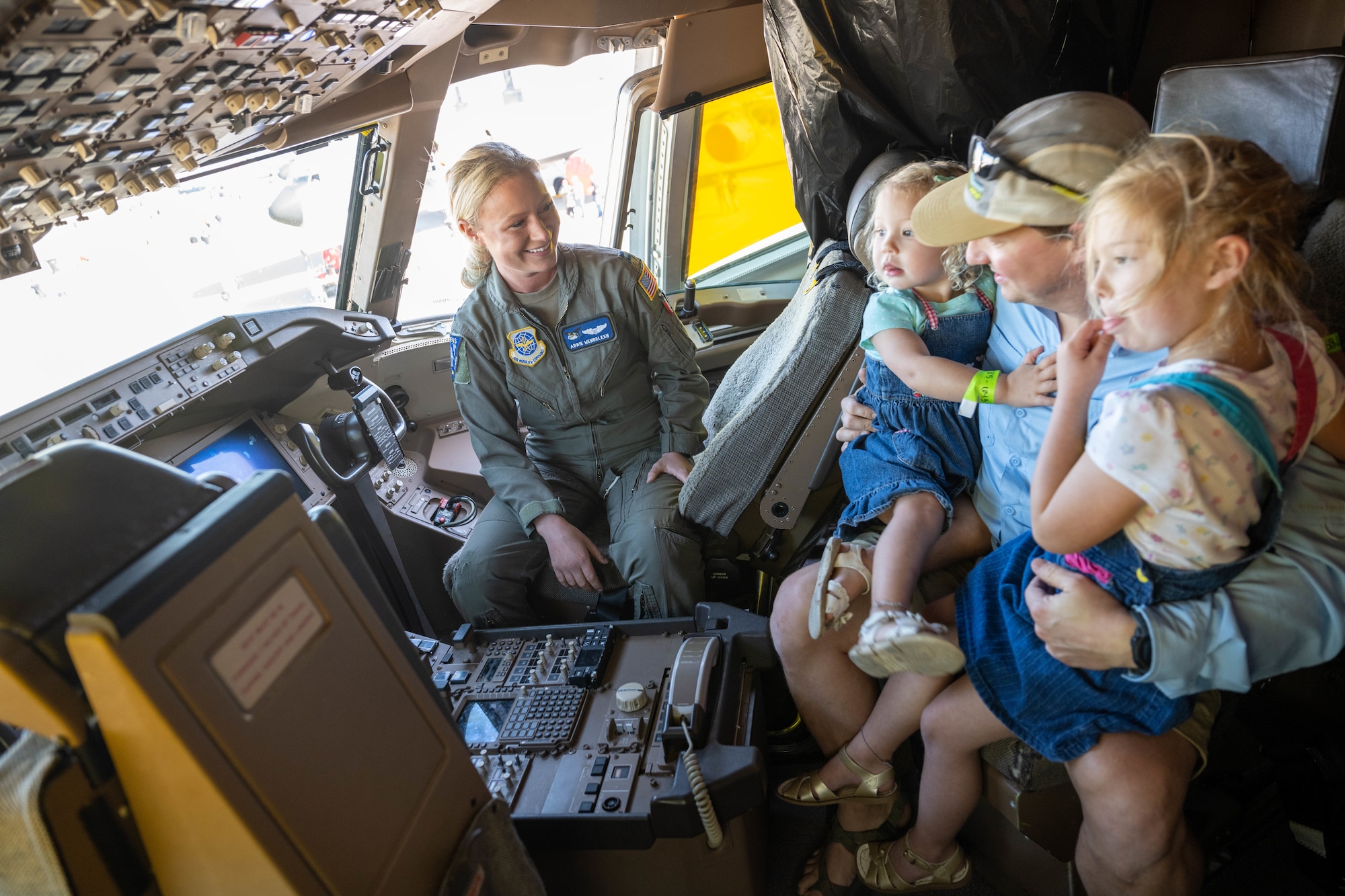 Two little girls learn about the KC-46 Pegasus, an air refueling aircraft, during the Frontiers in Flight Air show at McConnell Air Force Base, Kansas, Sept. 25, 2022. The air show featured 12 performers including Tora Tora Tora, an A-10 demonstration, and the U.S. Air Force Thunderbirds to name a few. An air show, also known as an open house, is a way for military members and installations to show appreciation to local communities as well as showcase Department of Defense and Air Force capabilities. Wichita, home to McConnell AFB, is known as the Air Capital of the World, the birthplace of some very famous airframes. (U.S. Air Force photo by Master Sgt. John Gordinier)