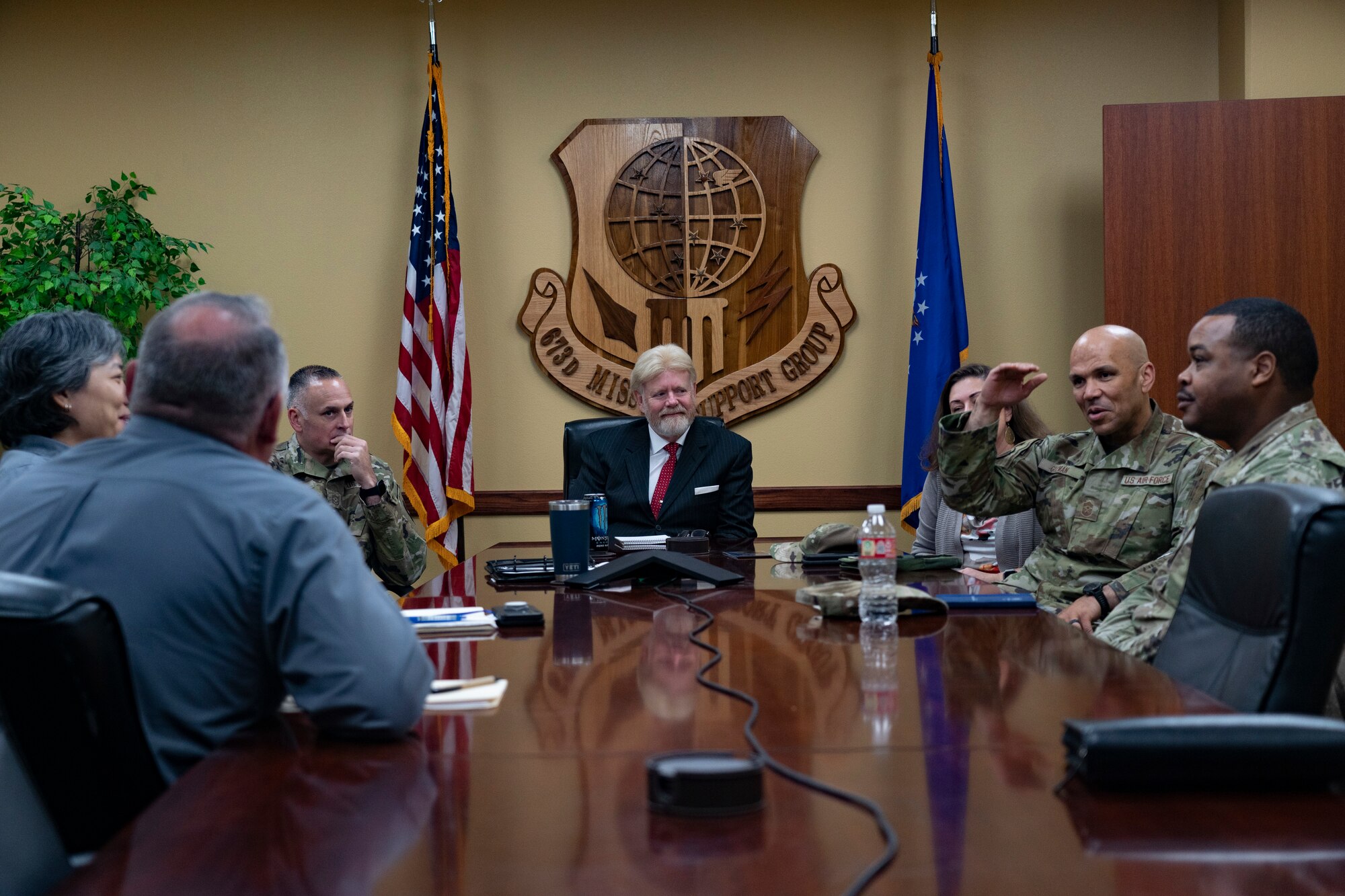 Senior enlisted leaders and Army and Air Force Exchange Service representatives talk during a meeting.