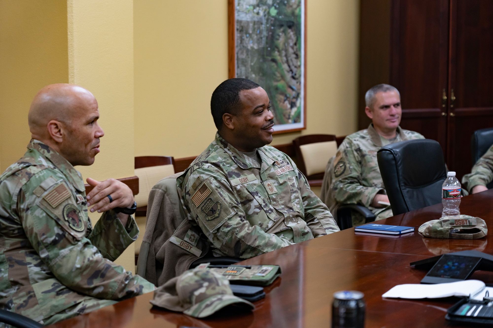 Senior enlisted leaders and Army and Air Force Exchange Service representatives talk during a meeting.