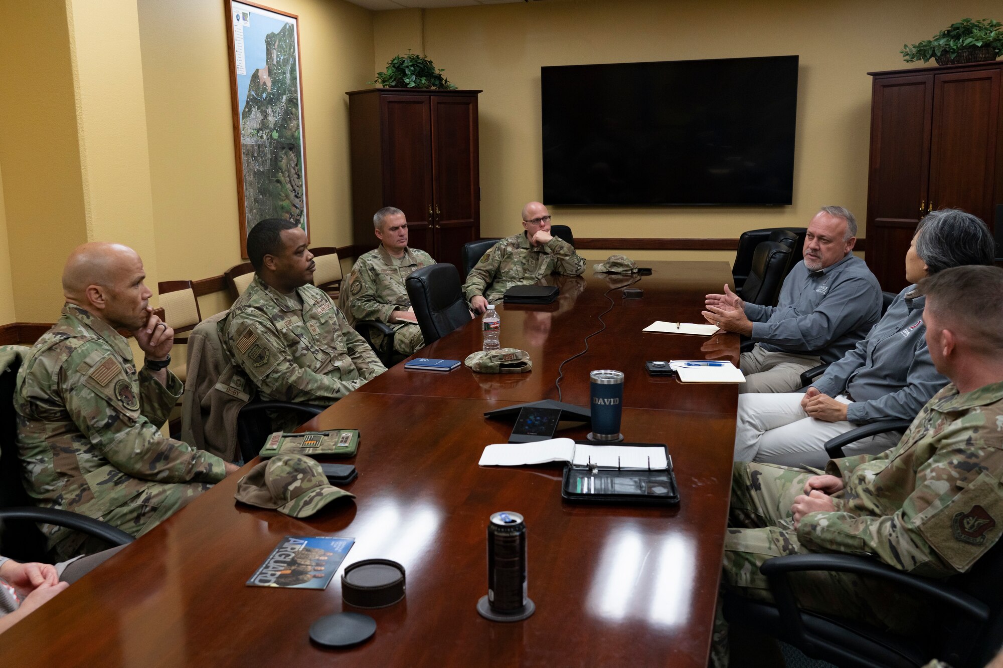 Senior enlisted leaders and Army and Air Force Exchange Service representatives talk during a meeting.