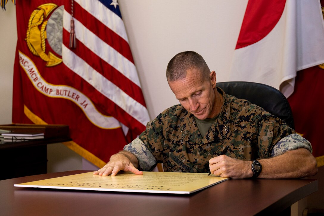 U.S. Marine Corps Maj. Gen. Stephen E. Liszewski, commanding general of Marine Corps Installations Pacific, Marine Corps Base Camp Butler, signs the Domestic Violence Awareness Month Proclamation at the MCIPAC headquarters building, Camp Foster, Okinawa, Japan, Oct. 3, 2022. The proclamation is signed annually to recognize the importance of preventing domestic violence. (U.S. Marine Corps photo by Lance Cpl. Thomas Sheng)