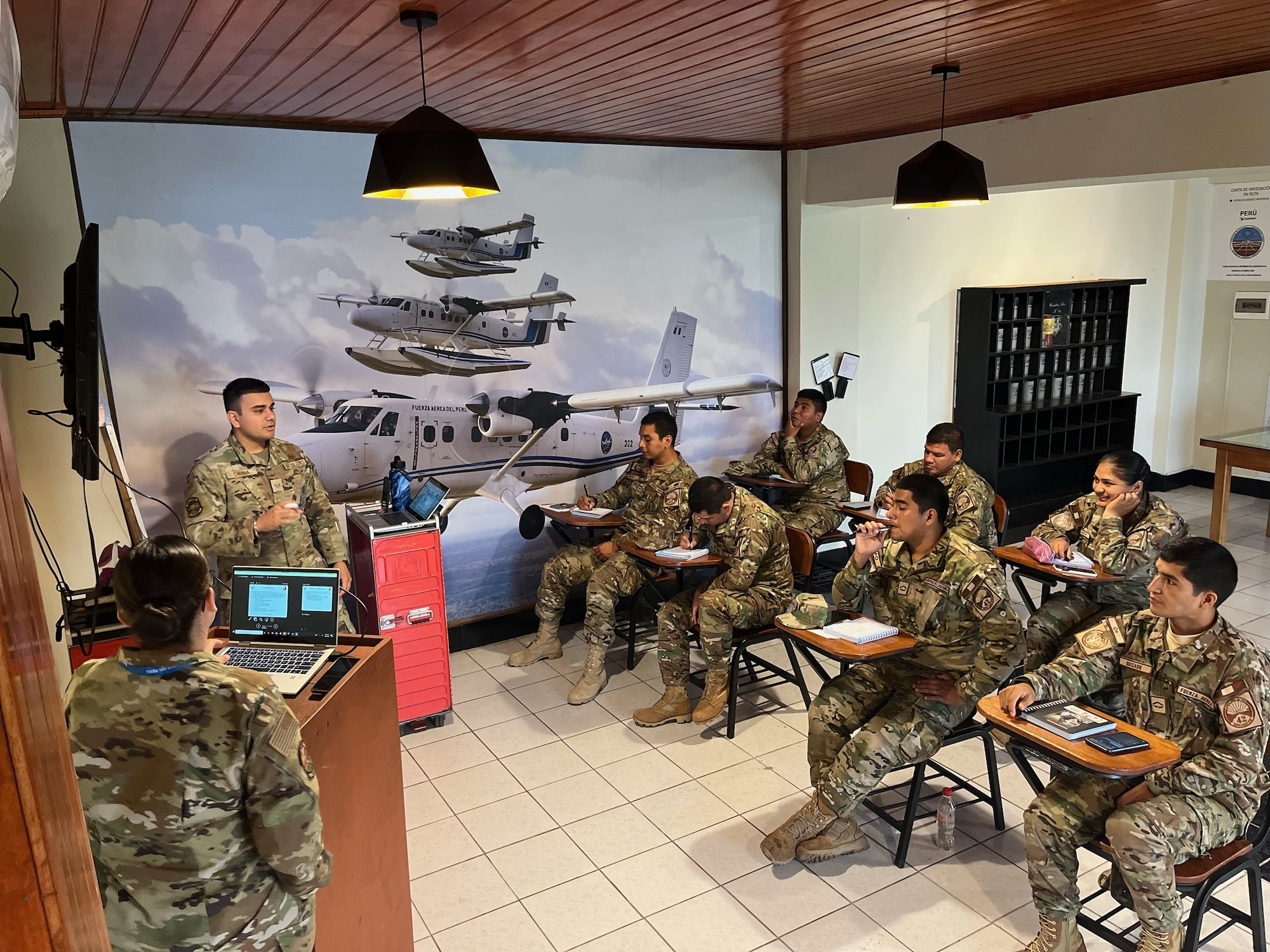 U.S. Air Force Staff Sgt. Sukhpreet Chinna, top left, a 571st Mobility Support Advisory Squadron advisor, instructs military service members of the Fuerza Aérea de Peru, Aug. 26, 2022, in Base Area Coronel Francisco Secada Vignetta Air Base, Peru. The purpose of the training was to build partner capacity between the United States Air Force and the Peruvian Air Force equivalent, known as Fuerza Aérea de Peru (FAP). (U.S. Air Force photo by Tech. Sgt. Anthony Garcia)