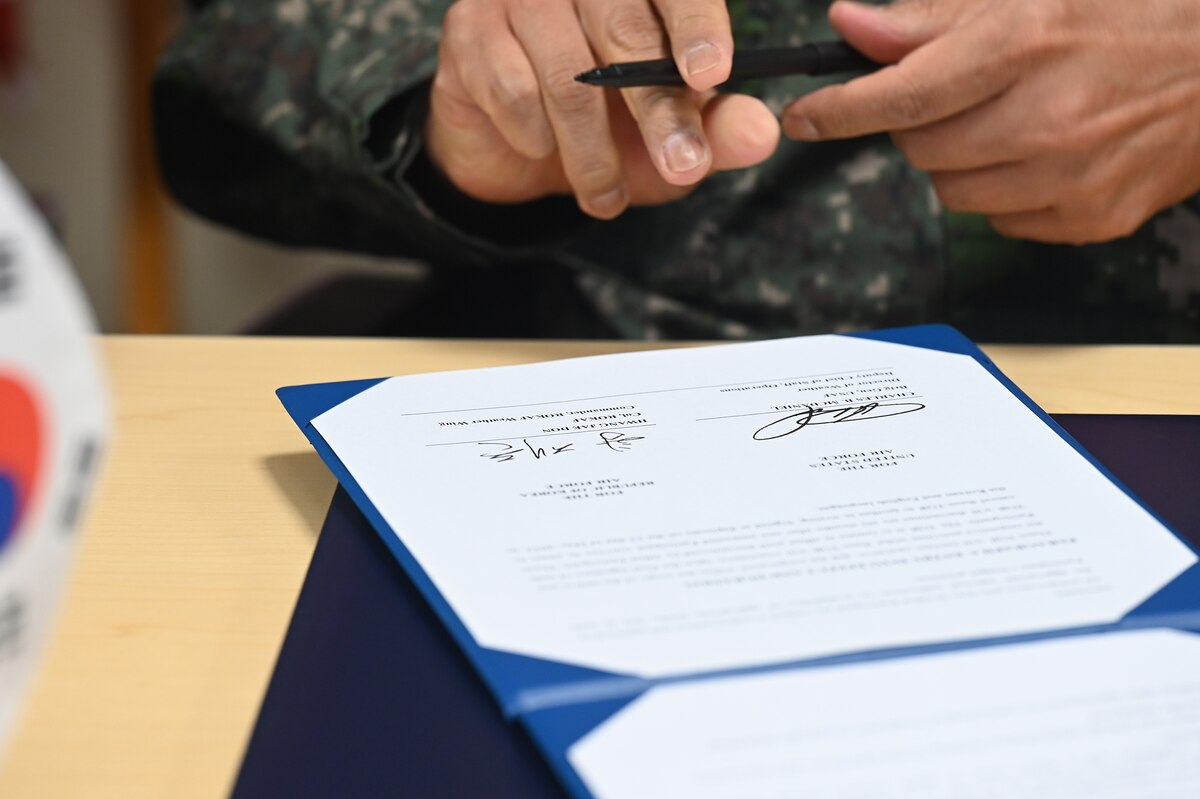 Republic of Korea Air Force Col. Hwang Jae Don, ROKAF Weather Wing commander, signs a Terms of Reference document during a meeting at the Pentagon in Arlington, Va., May 23, 2022. (U.S. Air Force photo by Andy Morataya)