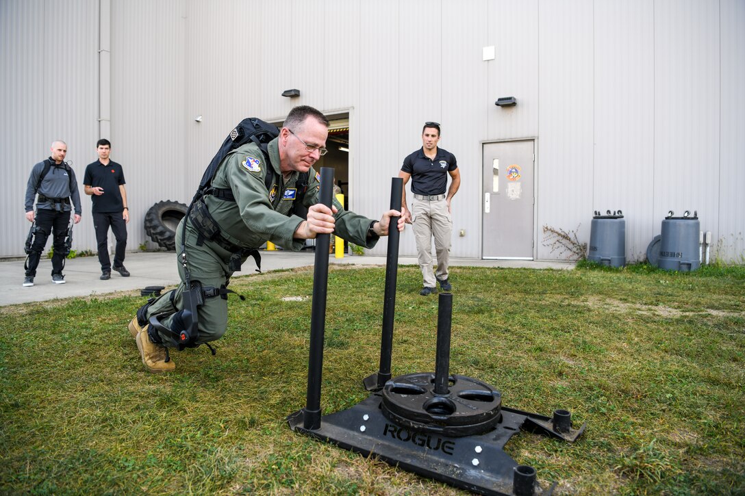 Brig. Gen. John Andrus, commander of 711th Human Performance Wing in the Air Force Research Laboratory, pushes a weighted sled while wearing the pneumatically-powered exoskeleton during an AFRL demonstration Oct. 6, 2022, at the Air Force Reserve Command’s 445th Airlift Wing, Wright-Patterson Air Force Base, Ohio.
