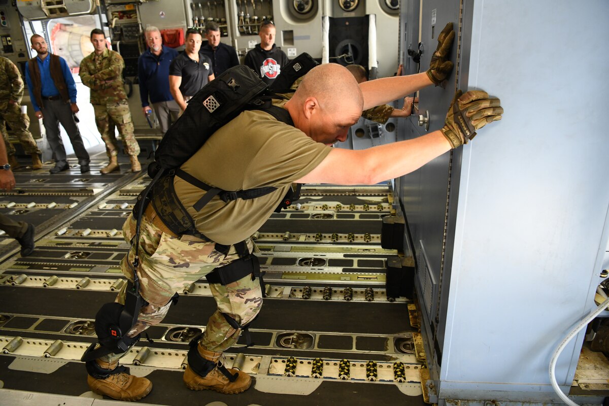 Chief Master Sgt. Sean Storms, aerial port manager with the Air Force Reserve Command’s 445th Airlift Wing, Wright-Patterson Air Force Base, Ohio pushes oversized cargo across the floor of a C-17 Oct. 6, 2022, during an Air Force Research Laboratory demonstration of a pneumatically-powered exoskeleton system developed by ROAM Robotics.