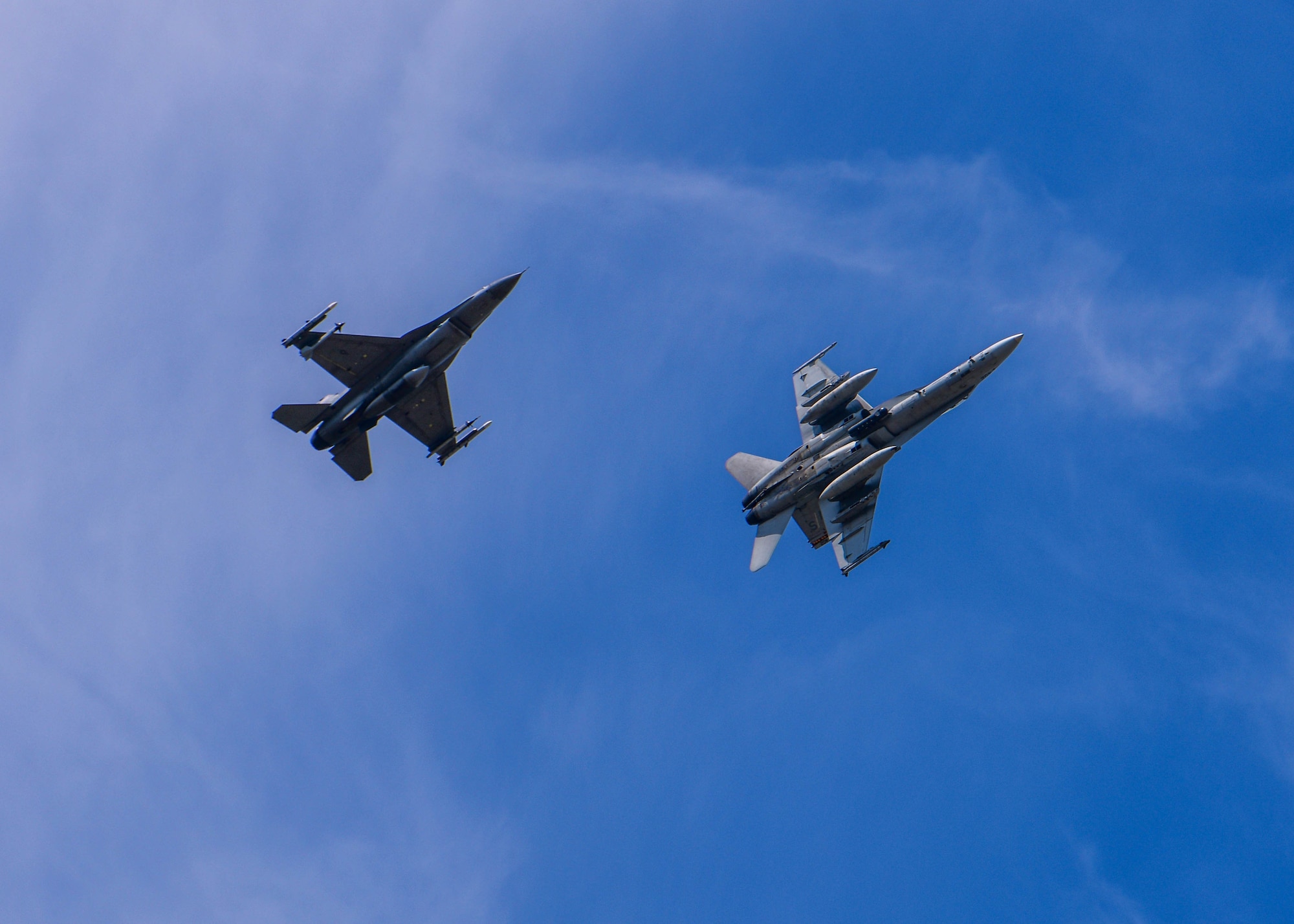 A U.S. Air Force F-16 Fighting Falcon assigned to the 510th Fighter Squadron, left, flies alongside a U.S. Marine Corps F/A-18 Hornet assigned to the Marine Fighter Attack Squadron 323 out of Marine Corps Air Station Miramar, California, at Aviano Air Base, Italy, Aug. 8, 2022. More than 200 U.S. Marines were deployed to Aviano AB for approximately two months in order to integrate and train with the 510th FS as part of a dynamic force employment. (U.S. Air Force photo by Senior Airman Brooke Moeder)