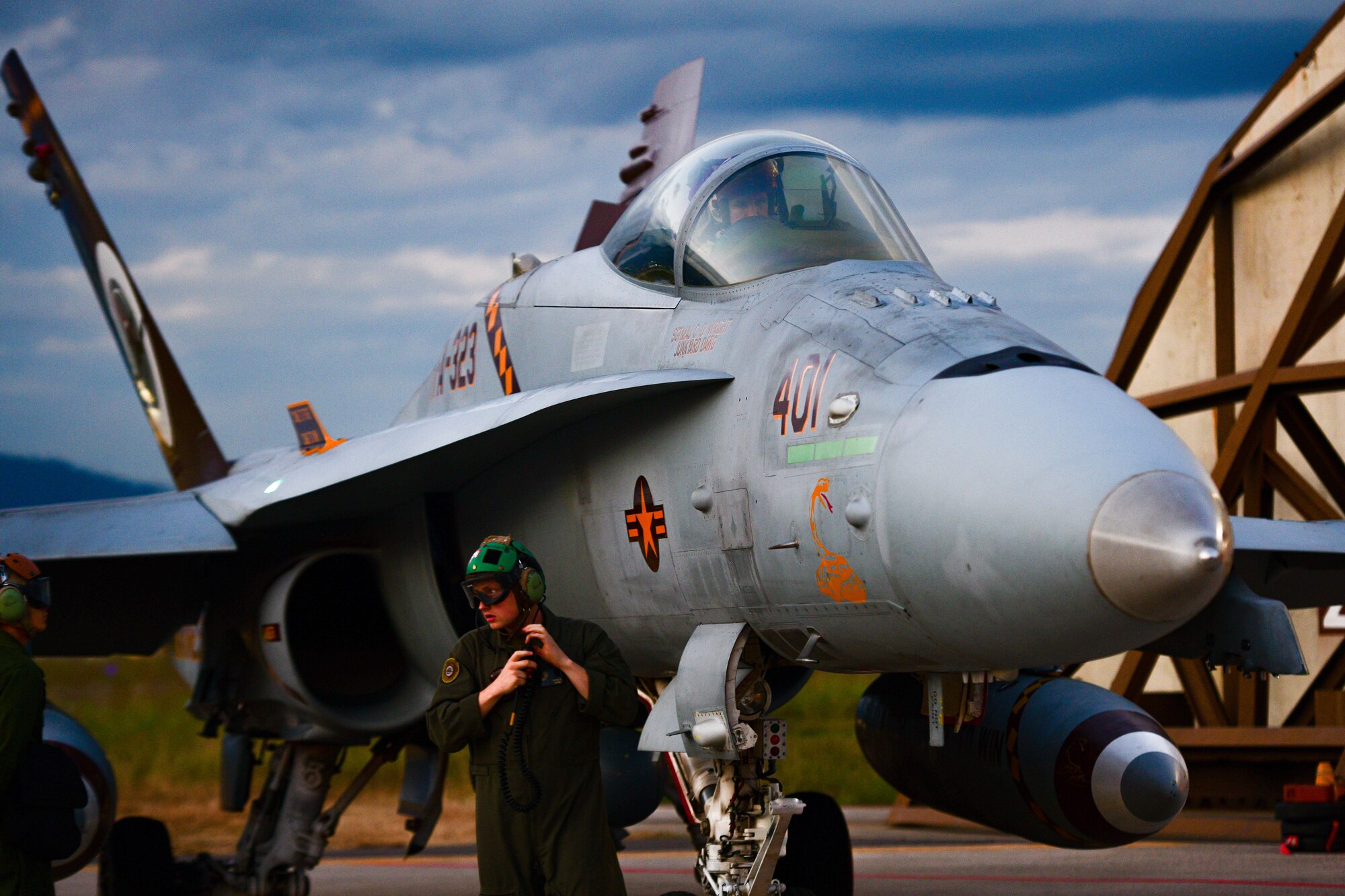 A United States Marine Corps F/A-18 fixed-wing aircraft mechanic prepares an F/A-18 Hornet assigned to the Marine Fighter Attack Squadron 323 based out of Marine Corps Air Station Miramar, California, for takeoff at Aviano Air Base, Italy, Sept. 20, 2022. During the flights they had opportunities to identify strengths, weaknesses and capabilities while also sharpening the skills and tactics shared between the 510th Fighter Squadron and the VMFA-323 Squadron. (U.S. Air Force photo by Senior Airman Brooke Moeder)