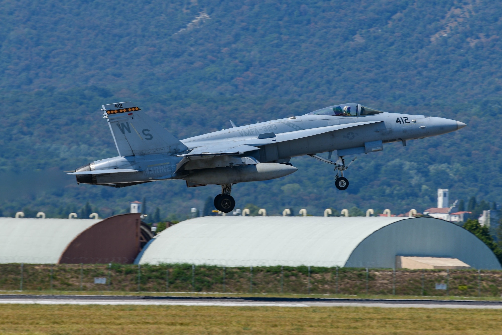 A U.S. Marine Corps F/A-18 Hornet assigned to the Marine Fighter Attack Squadron 323 out of Marine Corps Air Station Miramar, California, prepares to land at Aviano Air Base, Italy, Aug. 5, 2022. The VMFA-323 Squadron integrated with the 510th Fighter Squadron and practiced dogfighting, where one F-16 would be paired with one F-18 and whoever gets "gunned" loses. (U.S. Air Force photo by Senior Airman Brooke Moeder)