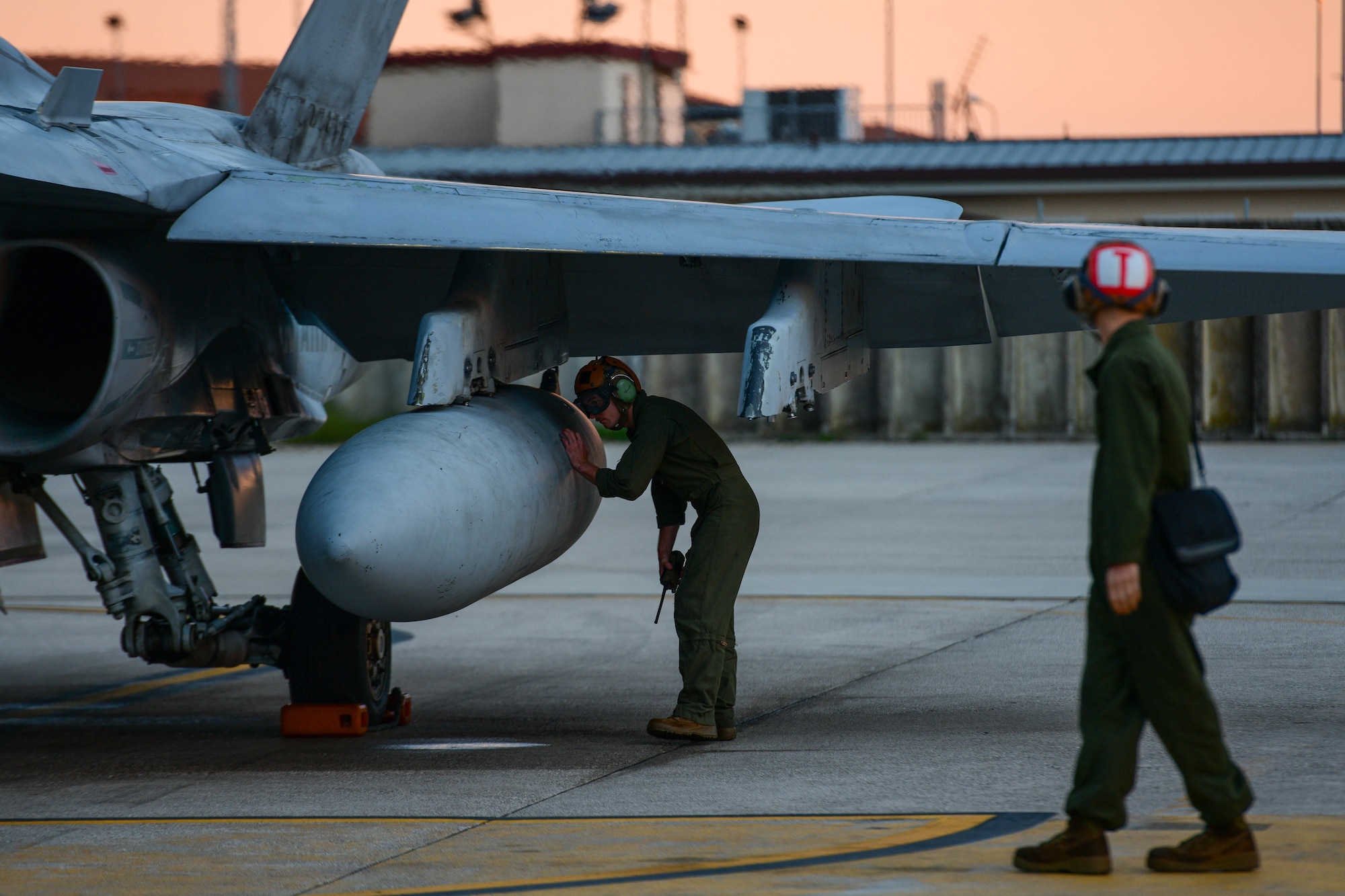 United States Marine Corps F/A-18 fixed-wing aircraft mechanics prepare an F/A-18 Hornet assigned to the Marine Fighter Attack Squadron 323 based out of Marine Corps Air Station Miramar, California, for flight at Aviano Air Base, Italy, Sept. 20, 2022. Fixed-wing aircraft mechanics inspect and maintain aircraft airframes and airframe components as well as perform additional duties relating to flightline operations. (U.S. Air Force photo by Senior Airman Brooke Moeder)