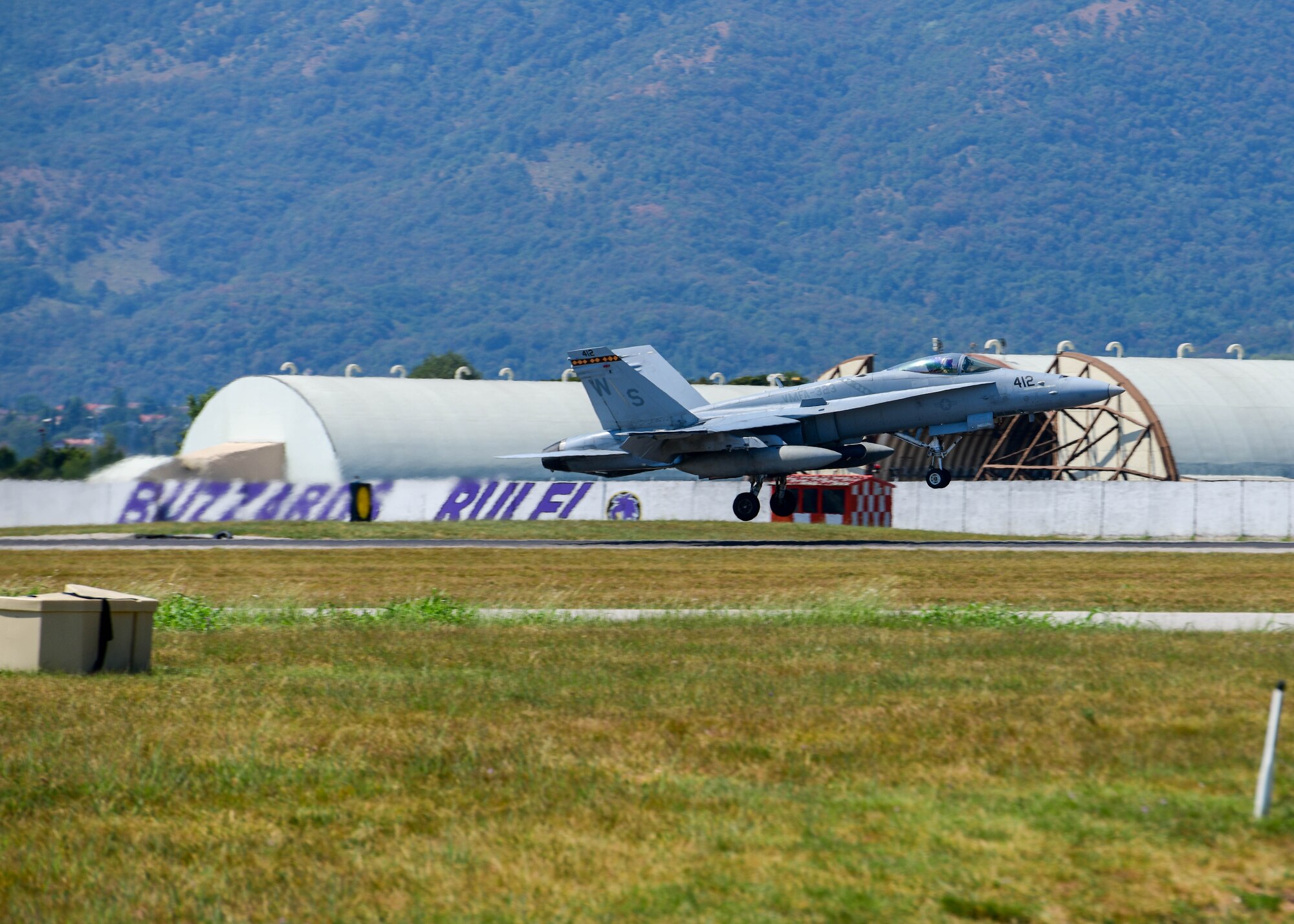 A U.S. Marine Corps F/A-18 Hornet assigned to the Marine Fighter Attack Squadron 323 out of Marine Corps Air Station Miramar, California, prepares to land at Aviano Air Base, Italy, Aug. 5, 2022. During the flights they had opportunities to identify strengths, weaknesses and capabilities while also sharpening their skills and tactics between the 510th Fighter Squadron and the VMFA-323 Squadron. (U.S. Air Force photo by Senior Airman Brooke Moeder)