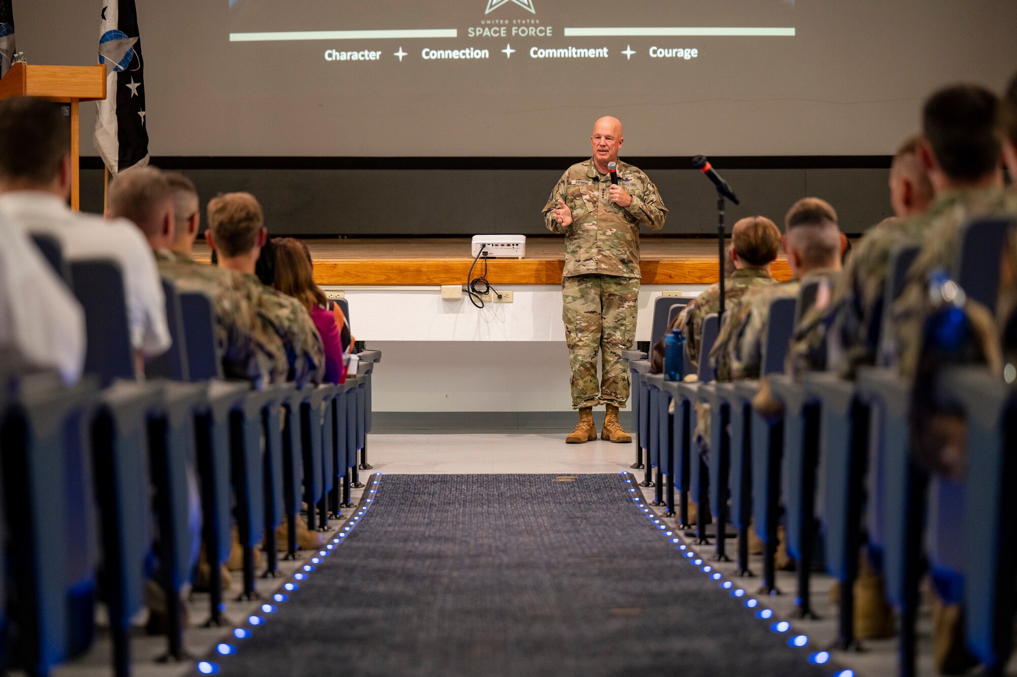 General talks to crowd.