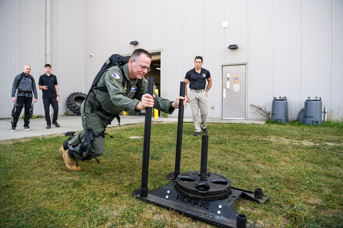 Brig. Gen. John Andrus, commander of 711th Human Performance Wing in the Air Force Research Laboratory, pushes a weighted sled while wearing the pneumatically-powered exoskeleton during an AFRL demonstration Oct. 6, 2022, at the Air Force Reserve Command’s 445th Airlift Wing, Wright-Patterson Air Force Base, Ohio.