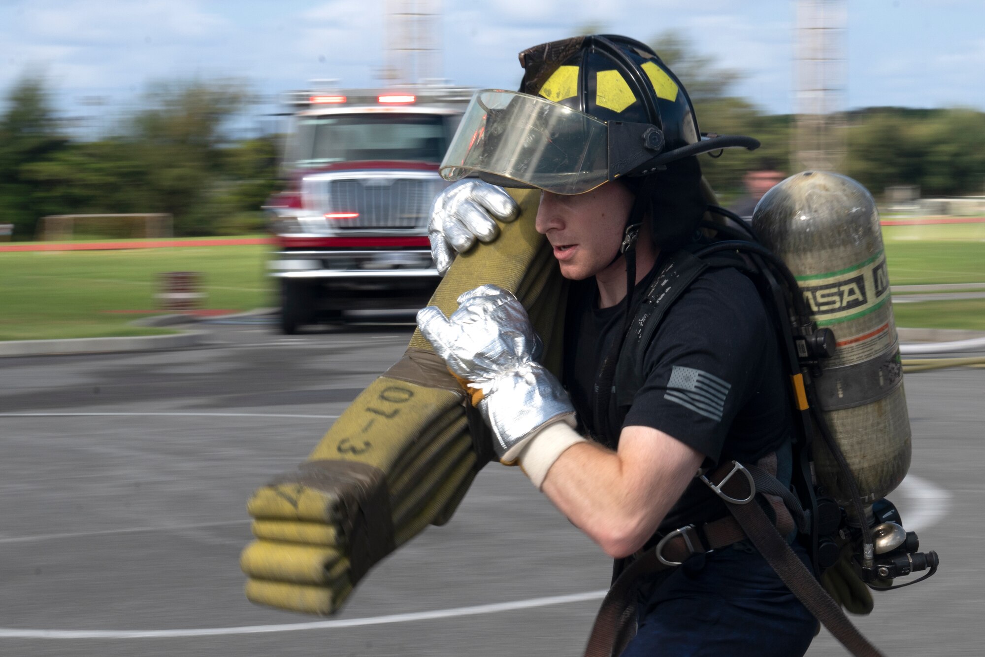 U.S. Air Force 2nd Lt. Adam Magistro, 18th Civil Engineer Squadron project programmer, participates in a relay event at the fire muster challenge during National Fire Prevention Week at Kadena Air Base, Japan, Oct. 6, 2022. The competitive event was part of a week-long effort to promote fire safety and prevention to the Team Kadena community. (U.S. Air Force photo by Senior Airman Jessi Roth)