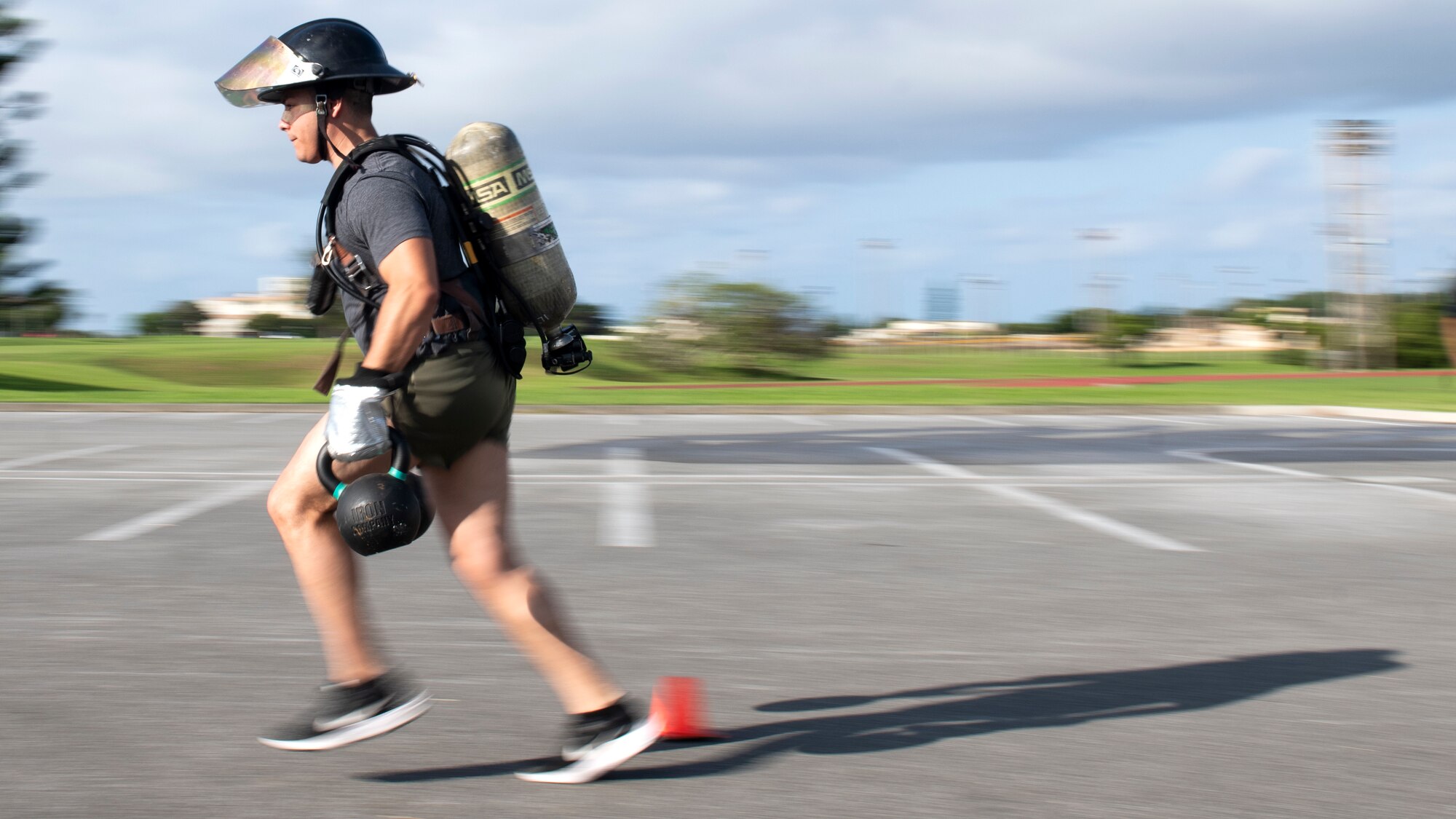Tech. Sgt. Justin Campos, 18th Civil Engineer Squadron explosive ordnance disposal technician, participates in the fire muster challenge kettlebell run during National Fire Prevention Week at Kadena Air Base, Japan, Oct. 6, 2022. The competition gave bystanders and participants an opportunity to see and experience the various types of physical exertion firefighters must prepare for when responding to emergencies. (U.S. Air Force photo by Senior Airman Jessi Roth)