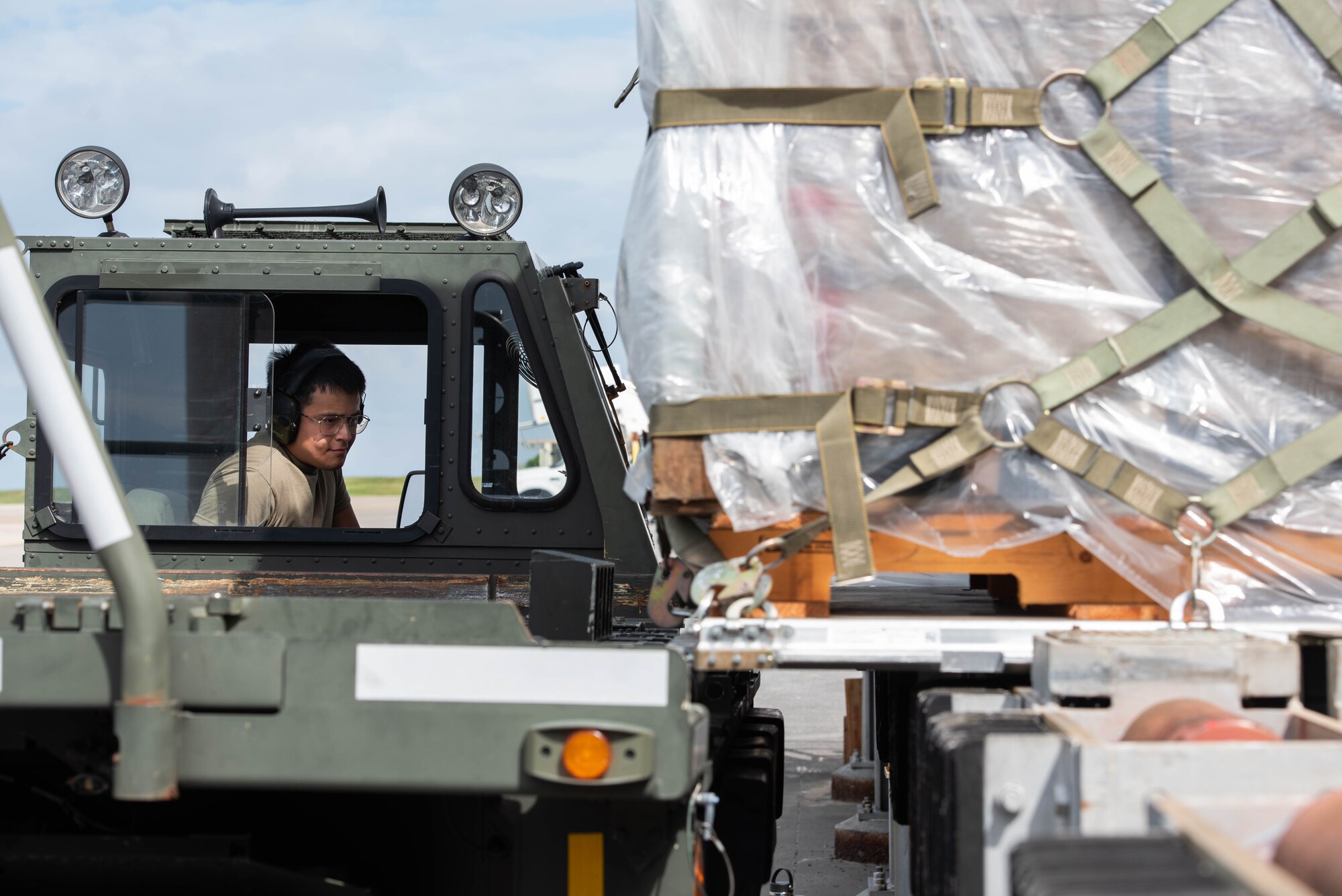An Airman moves cargo onto a loading vehicle.