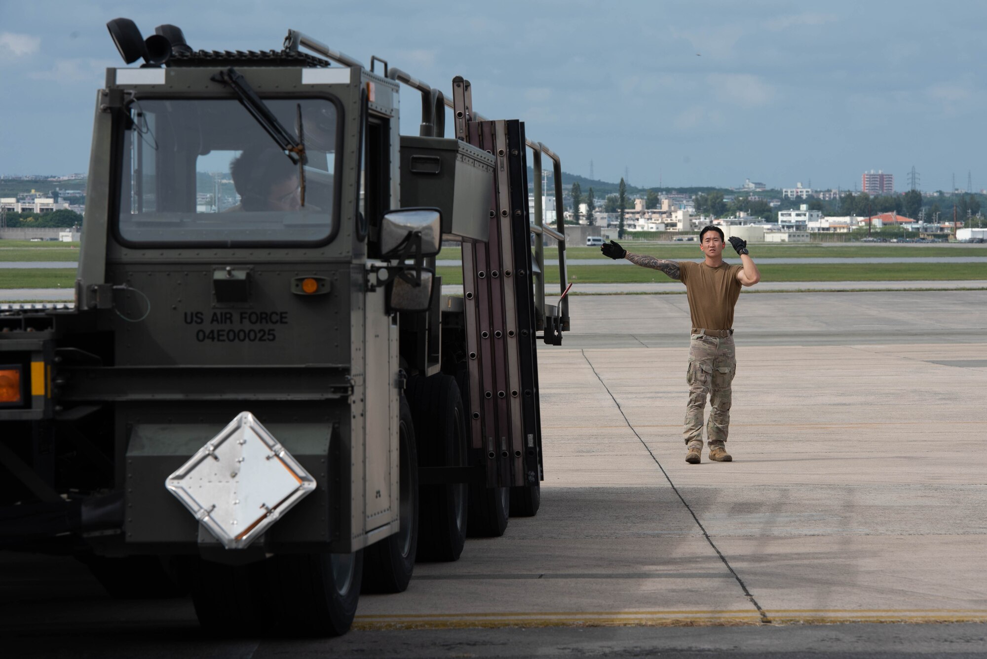 An Airman directs a cargo vehicle.