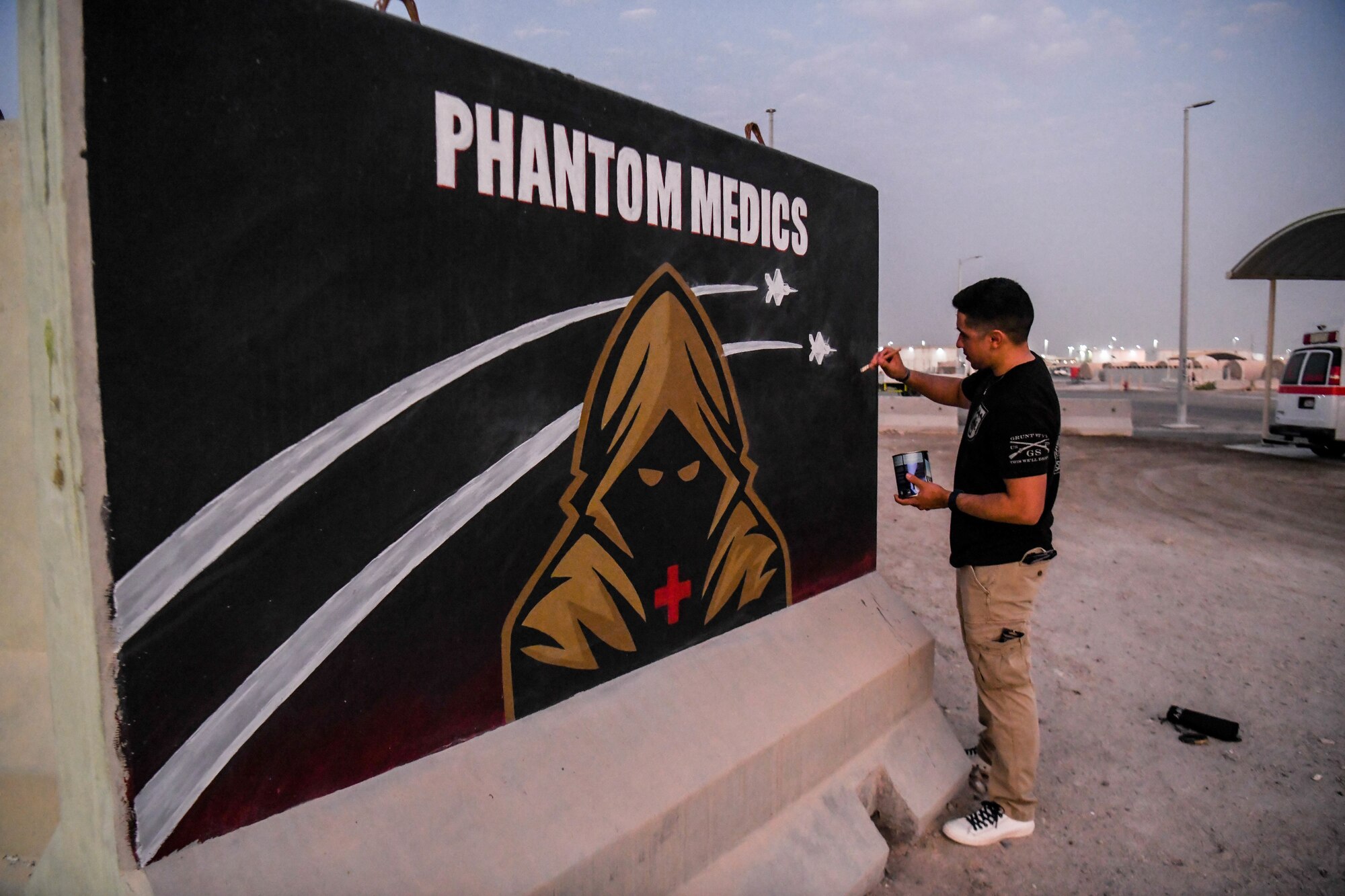 U.S. Army Sgt. Anthony Castillo, a mobility specialist assigned to the 3-157th Field Artillery unit and Colorado National Guardsmen, paints ten murals across Al Dhafra Air Base.