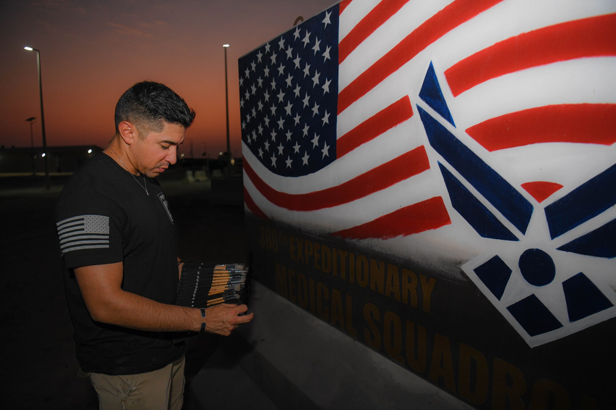 U.S. Army Sgt. Anthony Castillo, a mobility specialist assigned to the 3-157th Field Artillery unit and Colorado National Guardsmen, paints ten murals across Al Dhafra Air Base.
