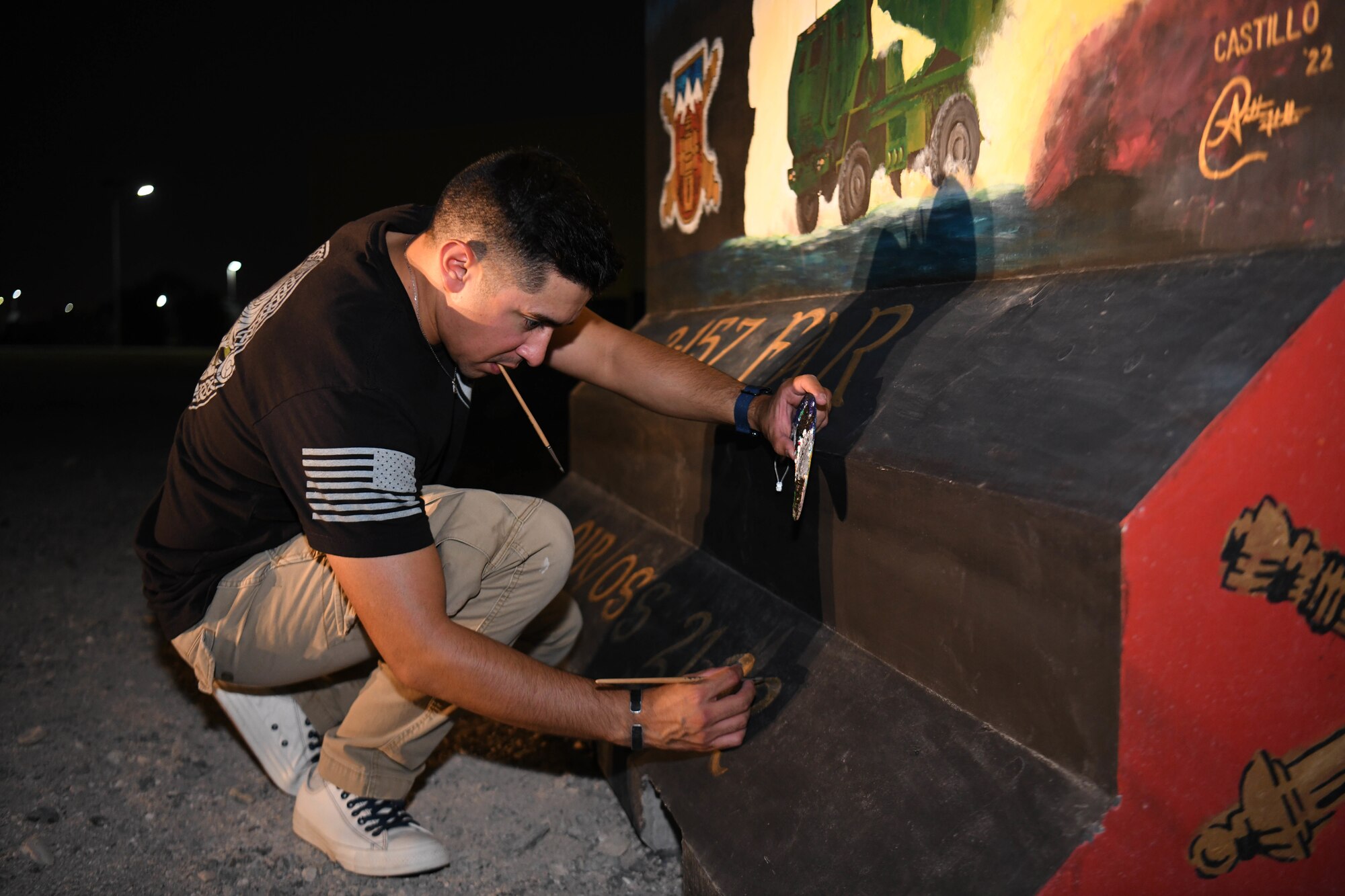 U.S. Army Sgt. Anthony Castillo, a mobility specialist assigned to the 3-157th Field Artillery unit and Colorado National Guardsmen, paints ten murals across Al Dhafra Air Base.