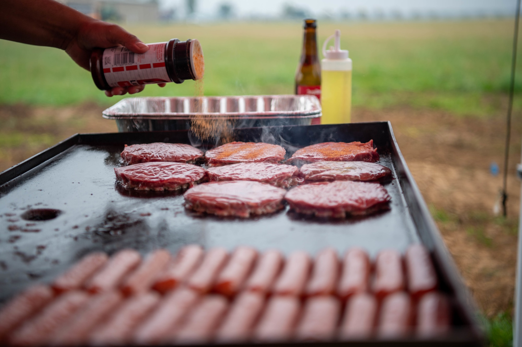 Burgers cook on a grill
