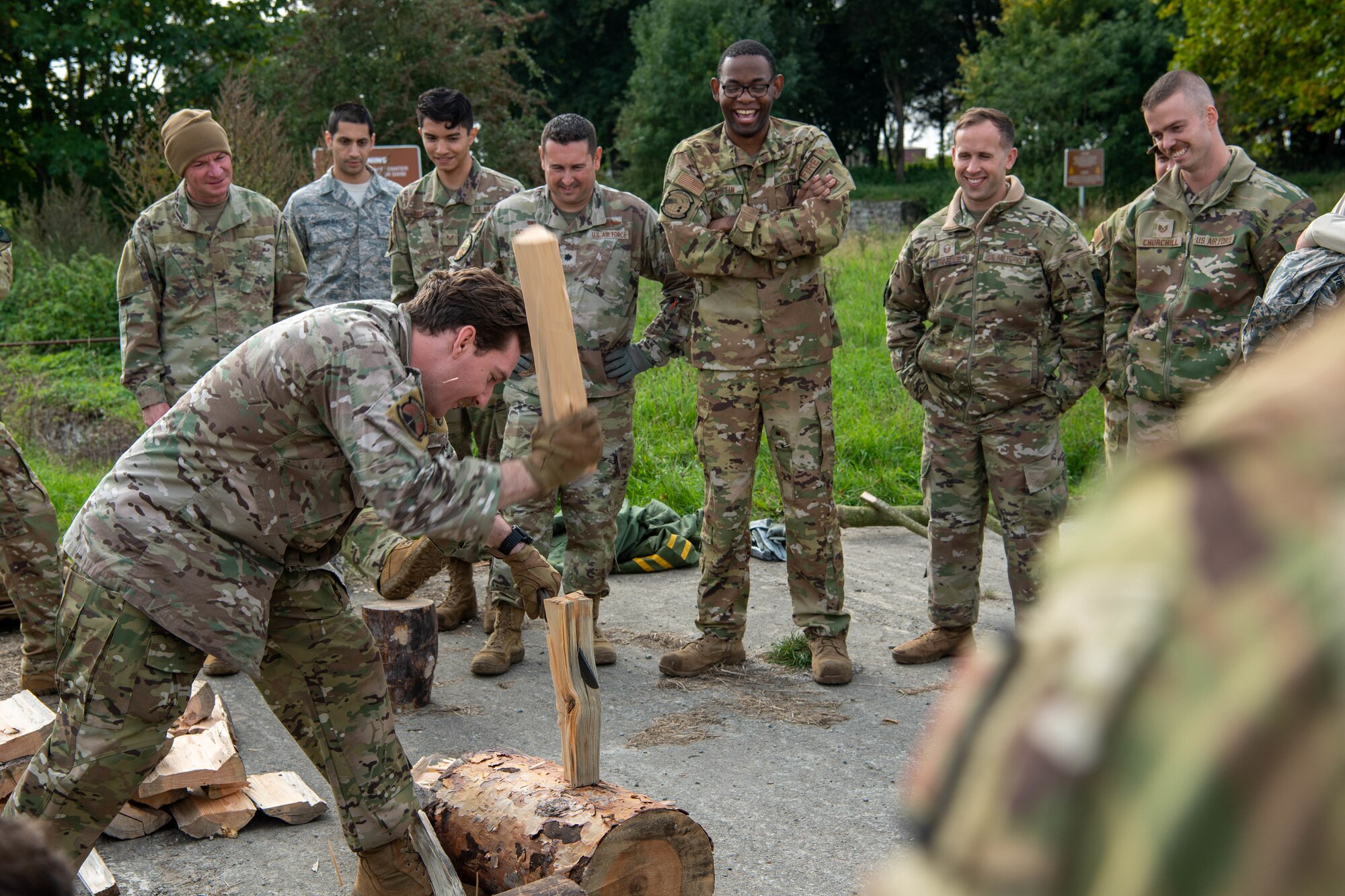 Instructors demonstrate wood cutting