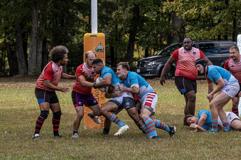 U.S. Marine Corps Corporal Ricardo Gonzalez Jr, an administrative specialist with Marine Corps Recruiting Command, and his teammate collide with the opponent team at Prince William County Rugby Football Club, Triangle, Va, on October 12, 2022. Gonzalez plays in the local rugby team while not playing for the All-Marine Rugby Team. (U.S. Marines Corps photo by Lance Cpl. Gustavo Romero)
