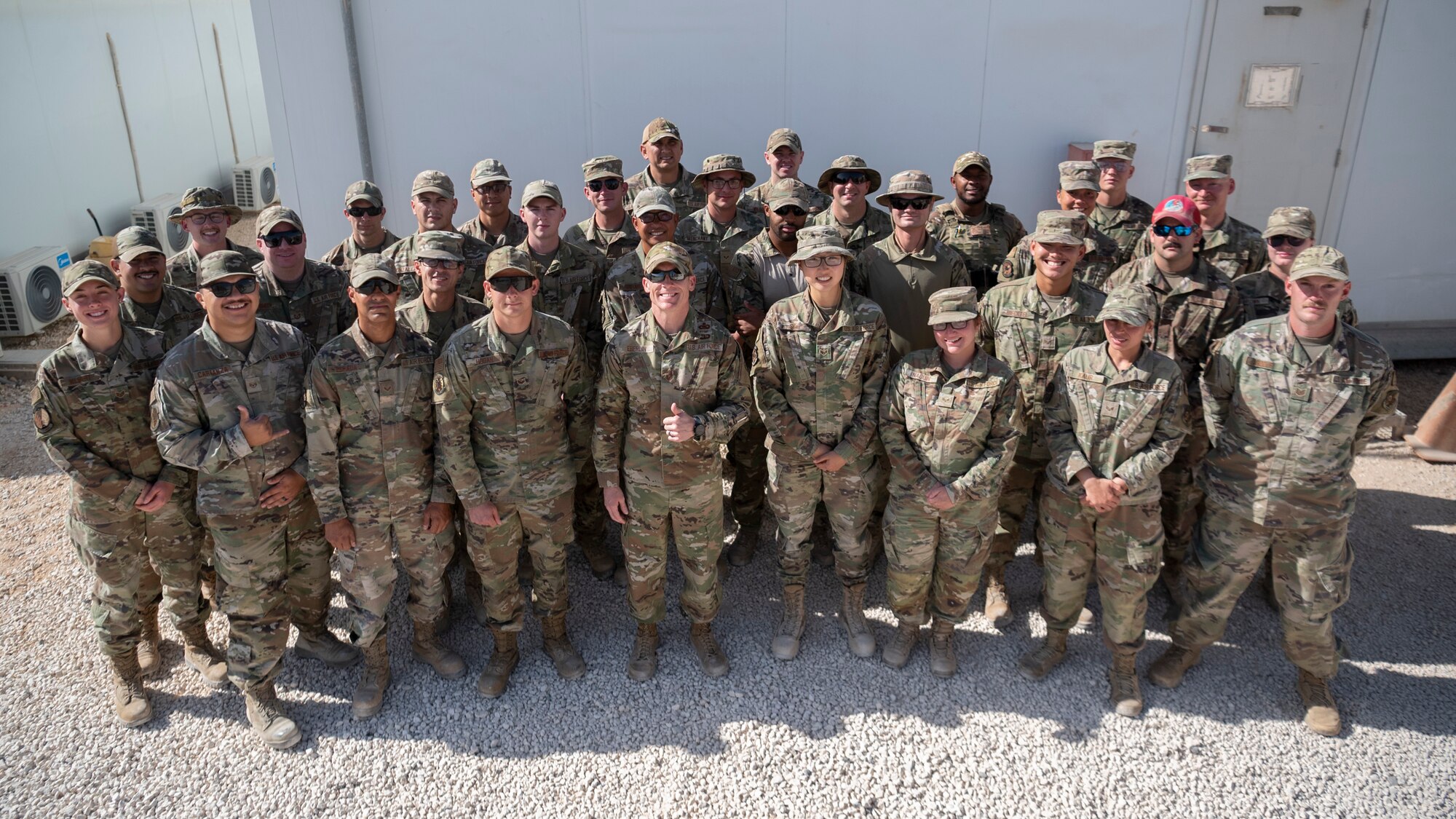 U.S. Air Force Chief Master Sergeant Kevin M. Eberlin, 332d Air Expeditionary Wing Command Chief, delivers commander’s coins to Airmen awarded for volunteering at the Airman’s Attic at an undisclosed location October 7, 2022. The commander’s coin is an on the spot way for senior leadership to show their appreciation for an excellent job. (U.S. Air Force photo by Tech. Sgt. Jeffery Foster)
