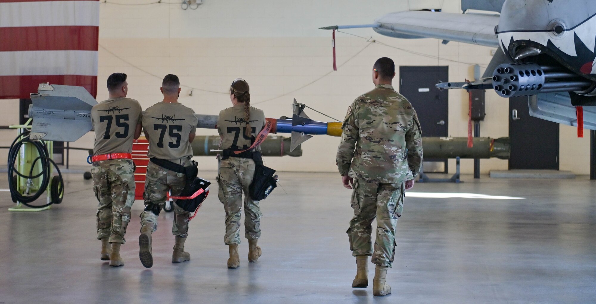 U.S. Air Force Airmen assigned to the 75th Fighter Generation Squadron carry a weapon to load onto an A-10C Thunderbolt II during a third quarter load crew competition at Moody Air Force Base, Georgia, Oct. 7, 2022. During these quarterly competitions, participants are required to do a uniform inspection, take a written exam and perform loading duties. (U.S. Air Force photo by Senior Airman Rebeckah Medeiros)