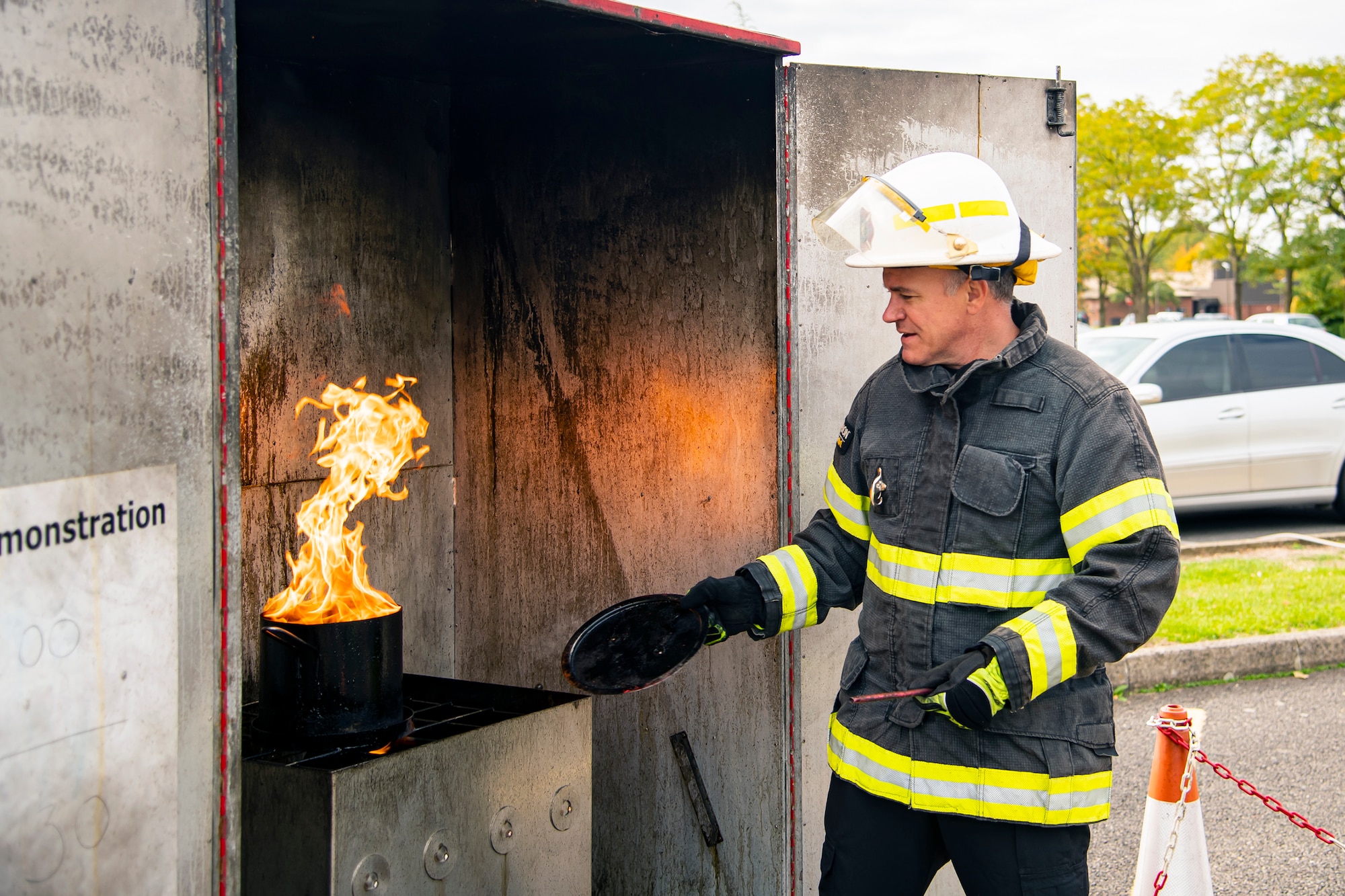 Dave Herman, 423d Civil Engineer Squadron assistant chief of fire prevention, conducts a grease fire demonstration at RAF Alconbury, England, Oct. 12, 2022. The demonstration was part of Fire Prevention Week in which firefighters from the 423d CES educated Airmen and dependents on proper fire safety habits. (U.S. Air Force photo by Staff Sgt. Eugene Oliver)
