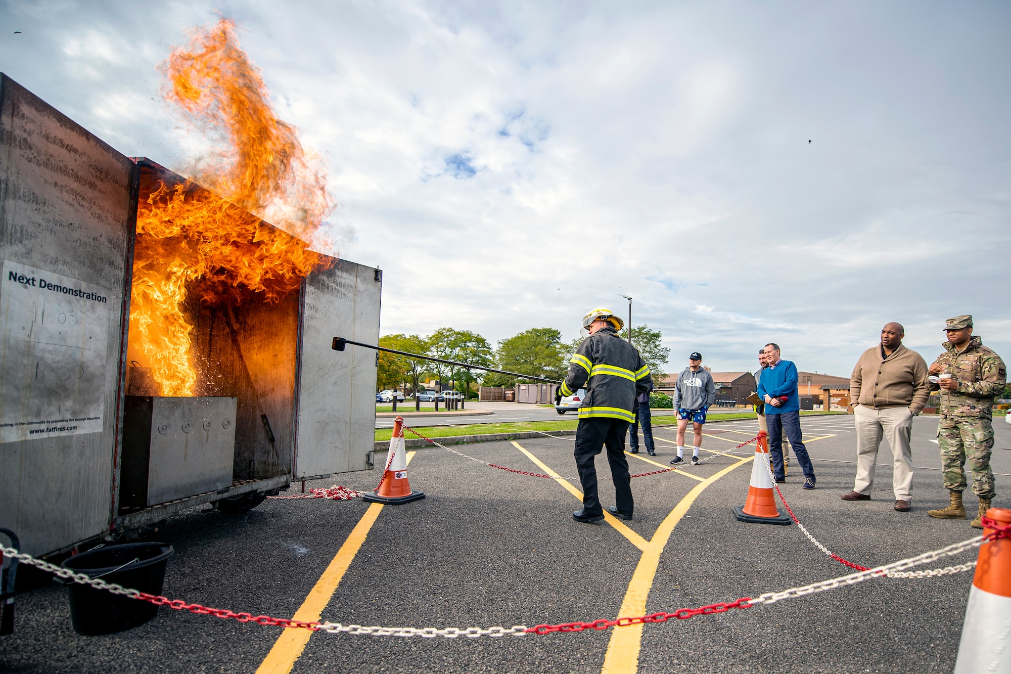 Dave Herman, 423d Civil Engineer Squadron assistant chief of fire prevention, demonstrates the dangers of a grease fire during a safety briefing at RAF Alconbury, England, Oct. 12, 2022.The demonstration was part of Fire Prevention Week in which firefighters from the 423d CES educated Airmen and dependents on proper fire safety habits. (U.S. Air Force photo by Staff Sgt. Eugene Oliver)