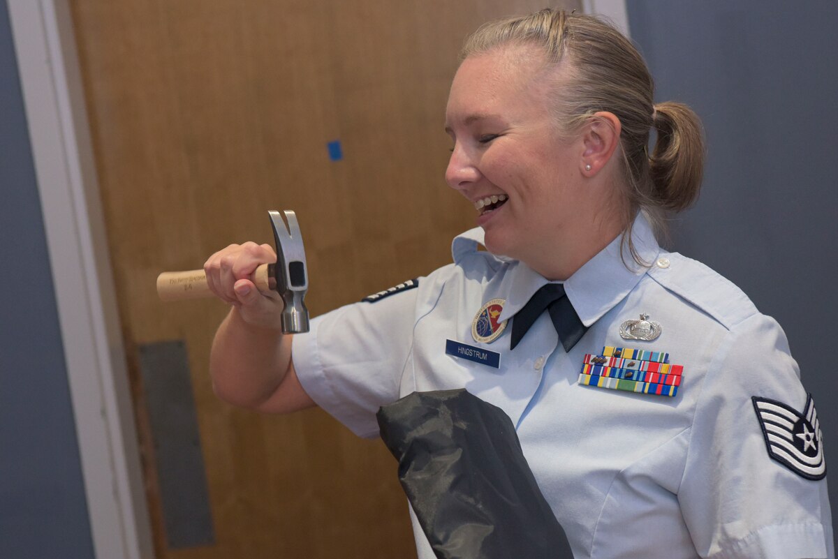 U.S. Air Force Tech Sgt. Kristin Hingstrum, 17th Force Support Squadron Airman Leadership School instructor, smiles as she receives a class gift donated by the graduates of ALS class 22-G, Goodfellow Air Force Base, Texas, Oct. 13, 2022. ALS is the first level of professional military education, and serves to educate Senior Airmen and Staff Sergeants as they transition into becoming supervisors. (U.S. Air Force photo by Senior Airman Michael Bowman)